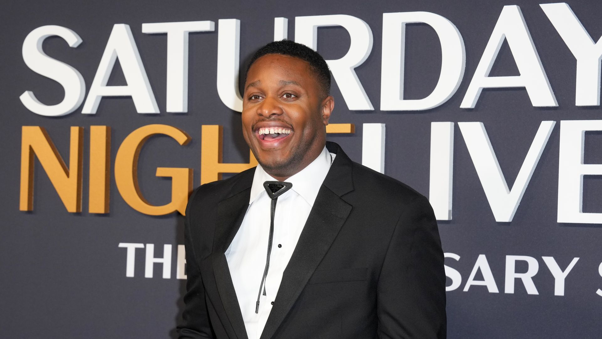 A photo of Devon Walker with the words "Saturday Night Live" behind him