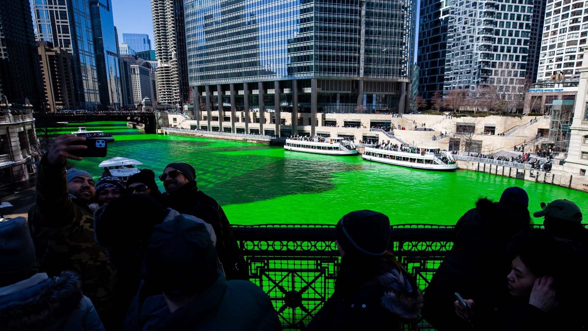 People looking at a green river