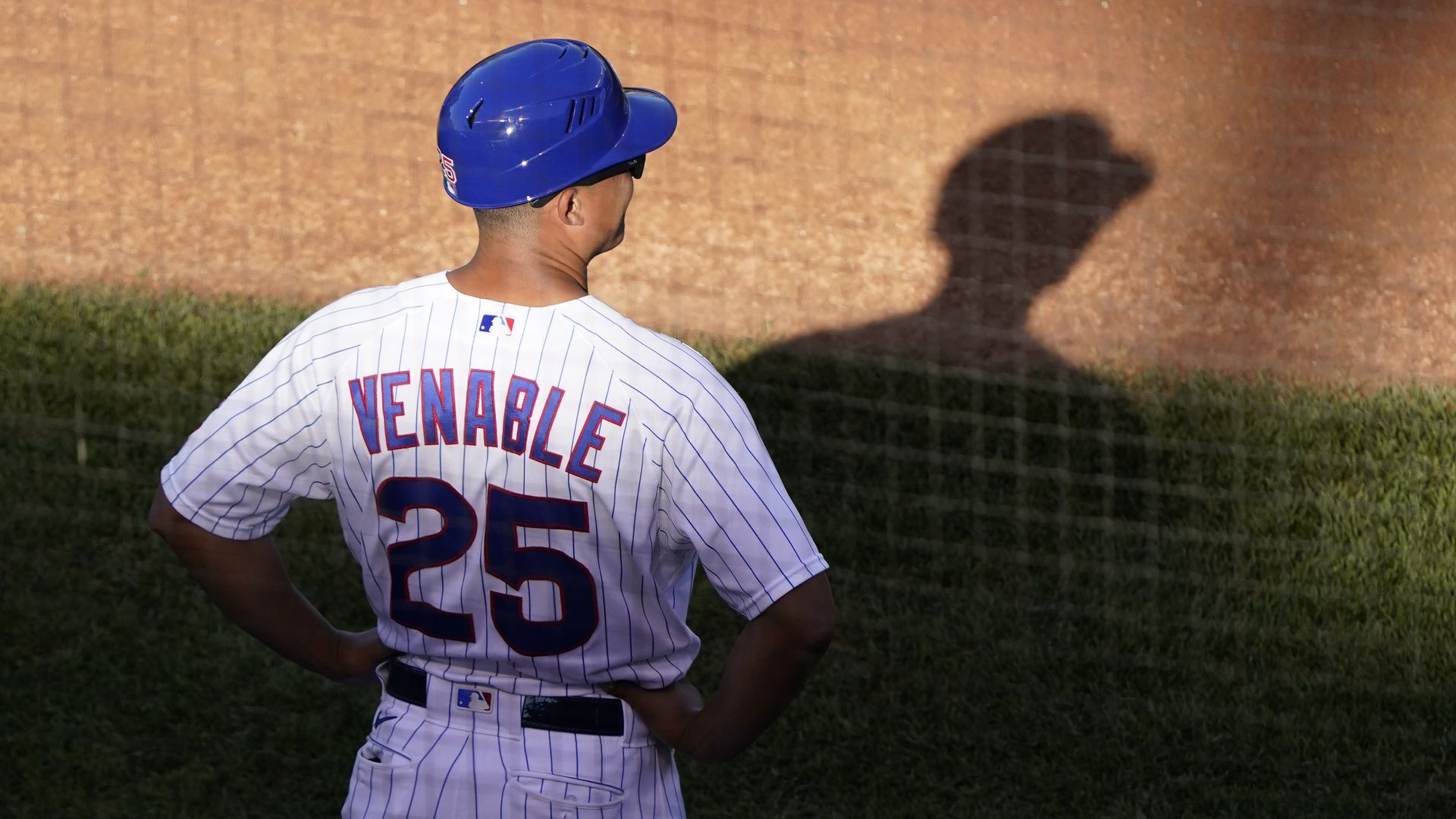 Photo of a man in a baseball uniform standing on the field.