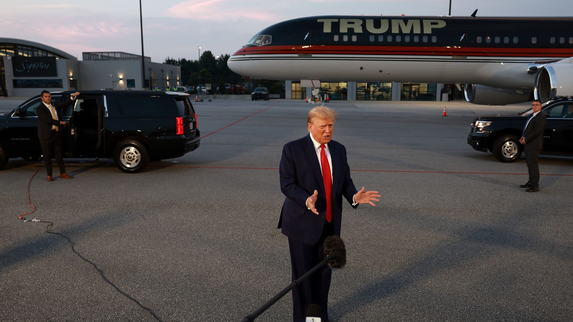 Former U.S. President Donald Trump speaks to the media at Atlanta Hartsfield-Jackson International Airport after surrendering at the Fulton County jail on August 24, 2023 in Atlanta, Georgia.