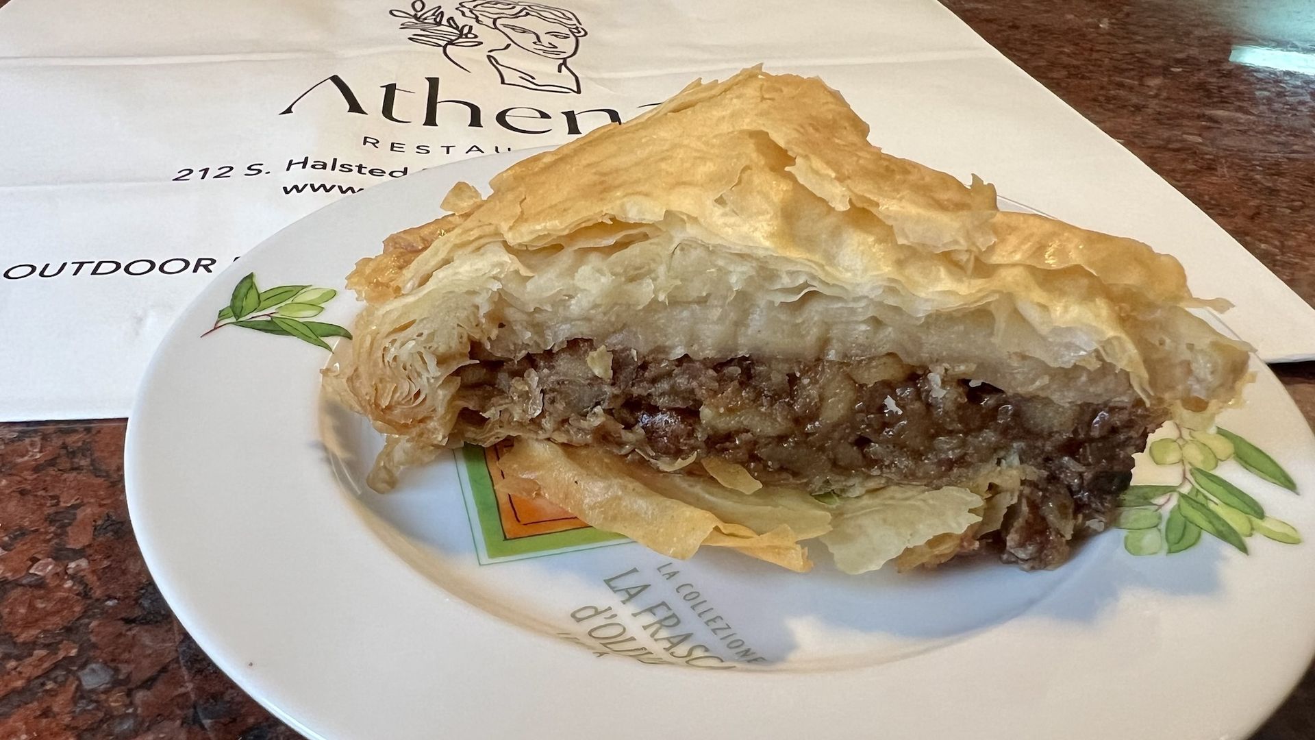 thick piece of baklava on white plate.