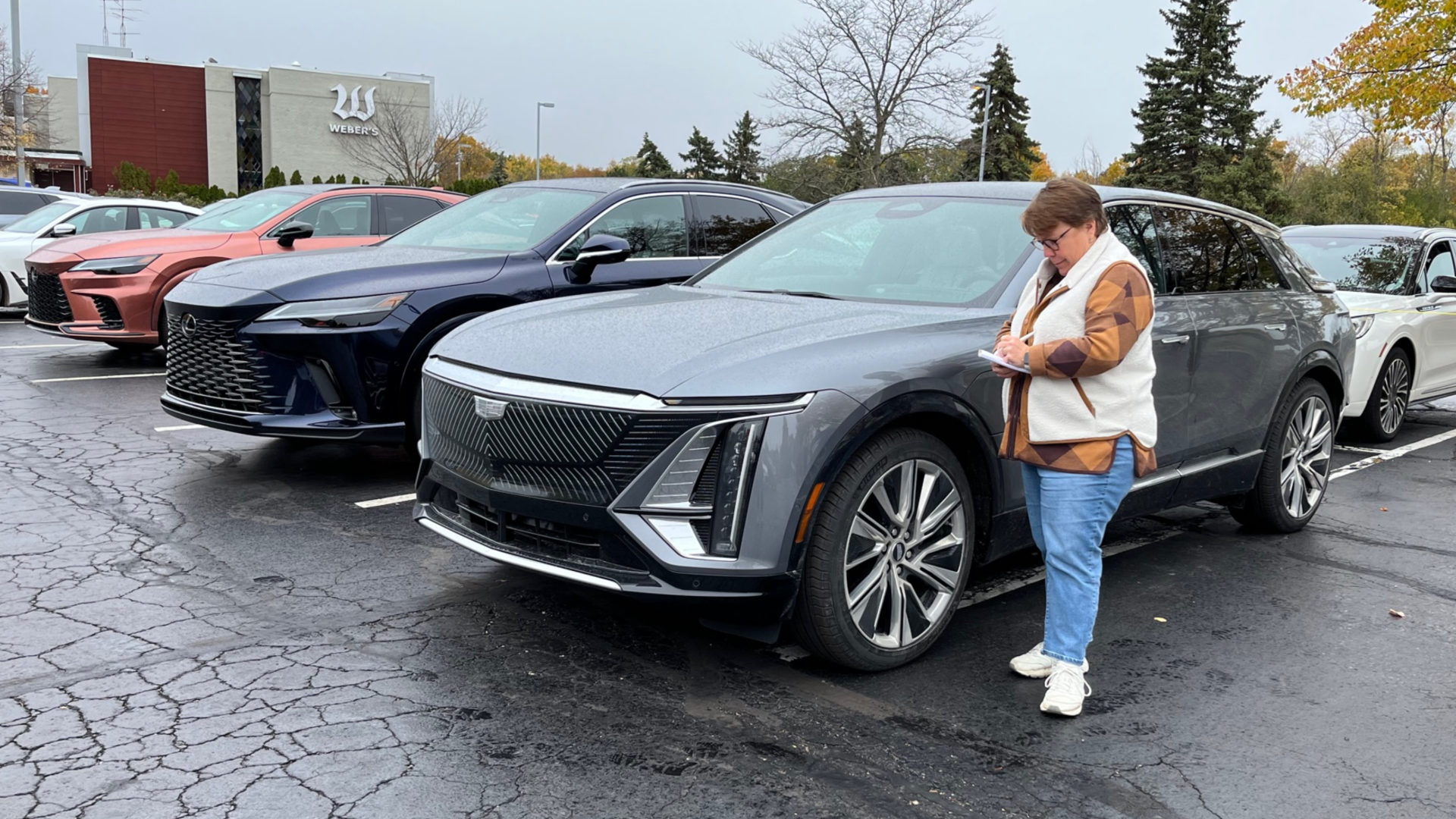Image of the author taking notes after test-driving the Cadillac Lyriq, an electric SUV