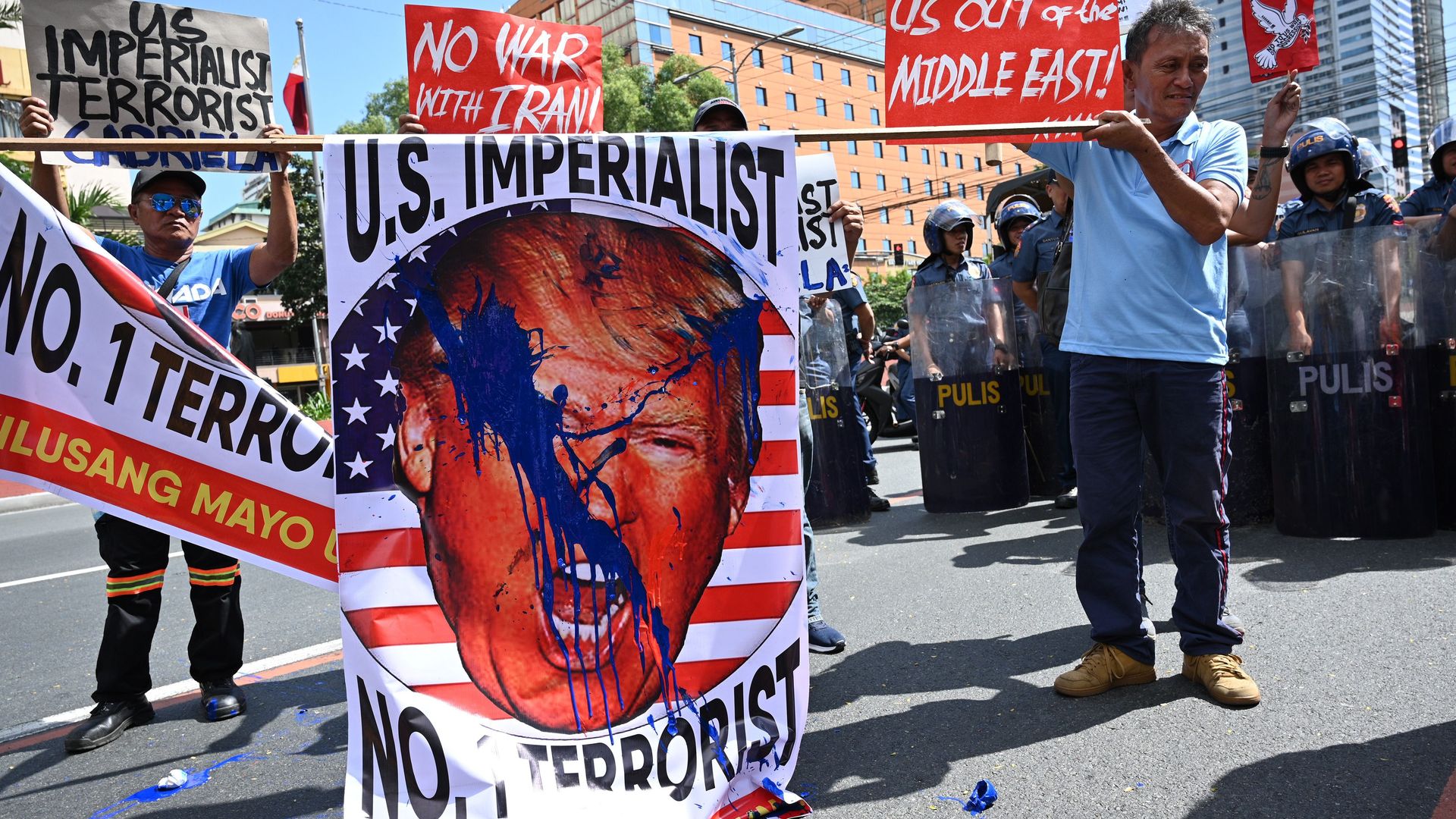 A photo of protesters in the Philippines carrying a sign calling President Trump the No. 1 terrorist.