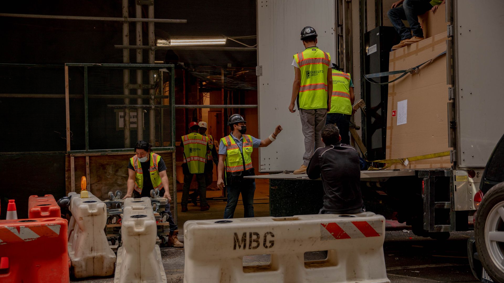 Photo of workers unloading furniture and appliances from a moving truck