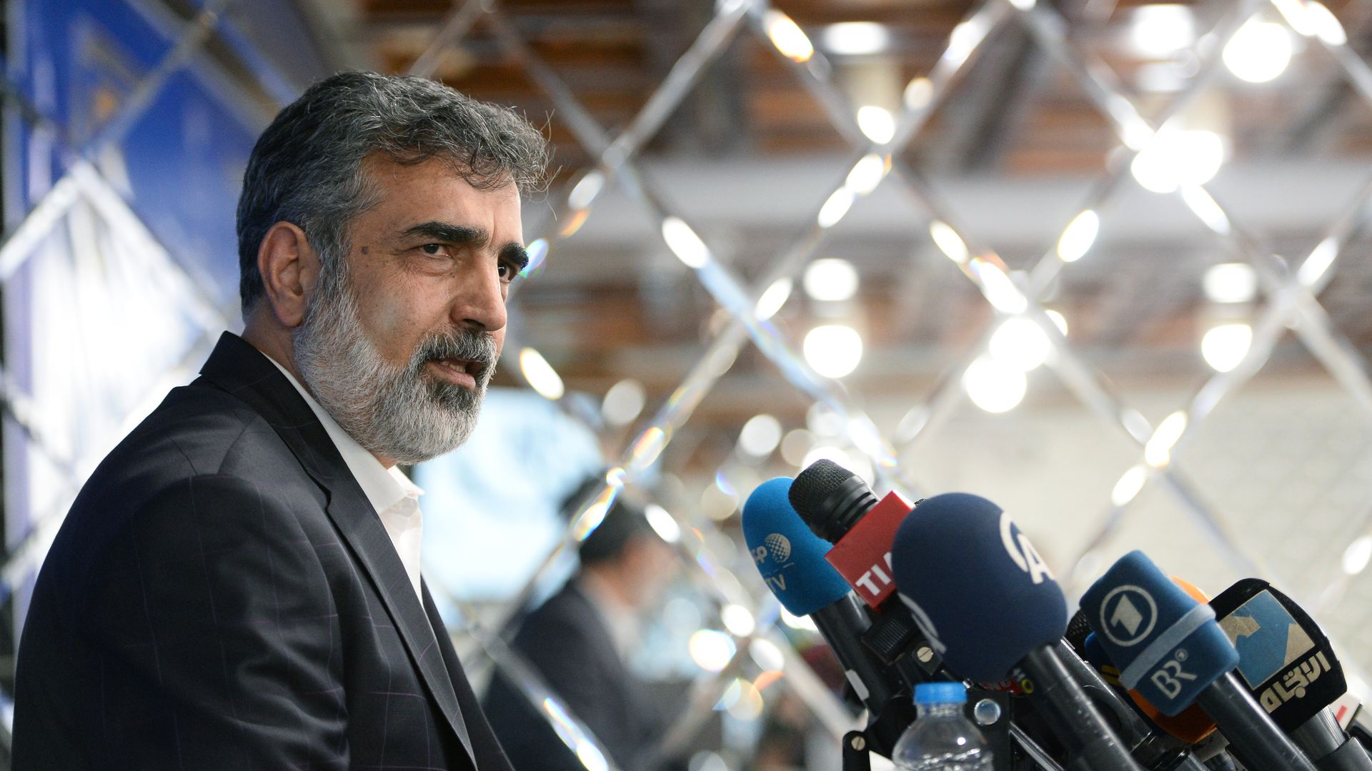 spokesman for Iran's atomic energy agency in front of microphones at a press conference
