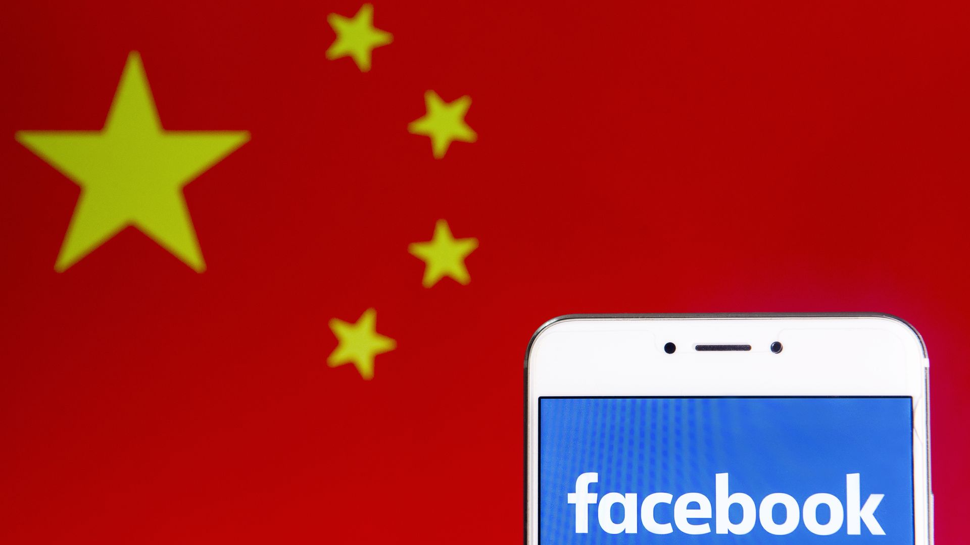 Photo illustration of the Facebook logo and the People's Republic of China flag.