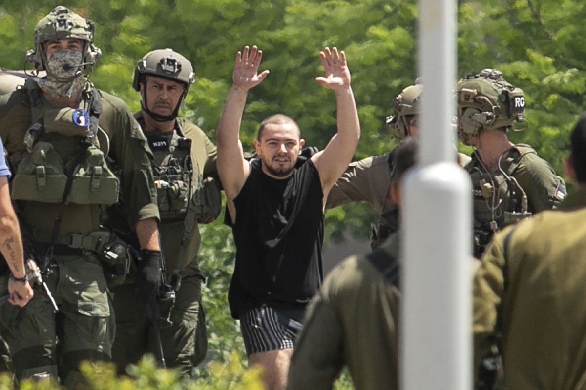 Almog Meir Jan, 22, kidnapped from Israel in a Hamas-led attack on Oct. 7, 2023, raises his hands after arriving by helicopter to the Sheba Medical Center