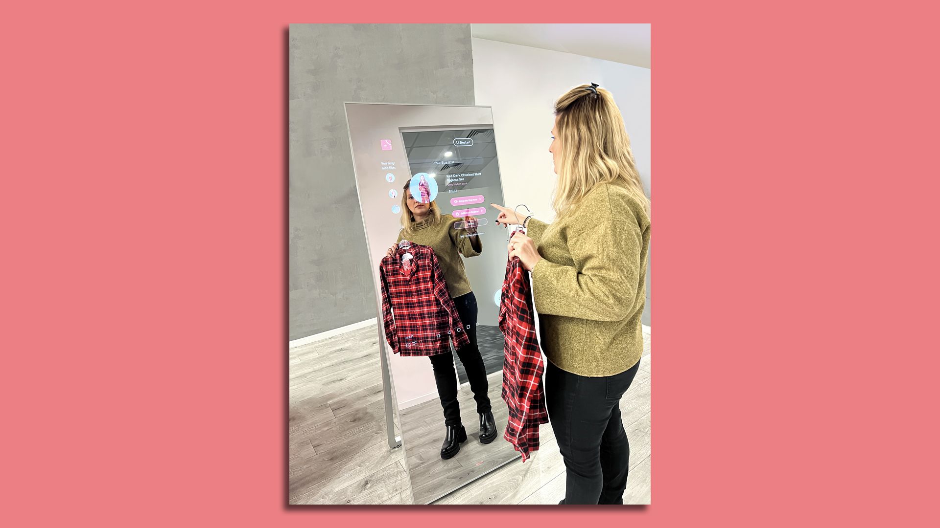 A woman standing in front of a "smart" mirror
