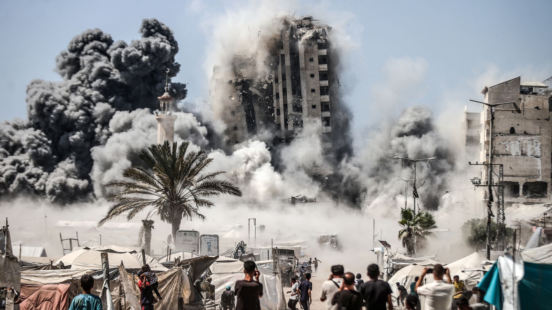 A high-rise building in Gaza City collapses after an Israeli strike on Friday. Photo: Ali Jadallah/Anadolu via Getty Images