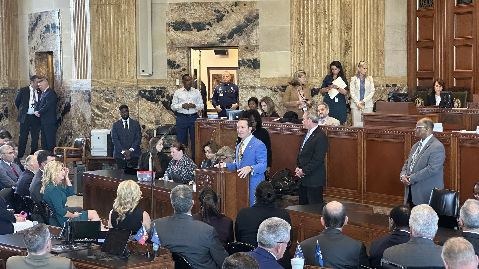 Gov. Jeff Landry speaks at a podium in the House chamber.