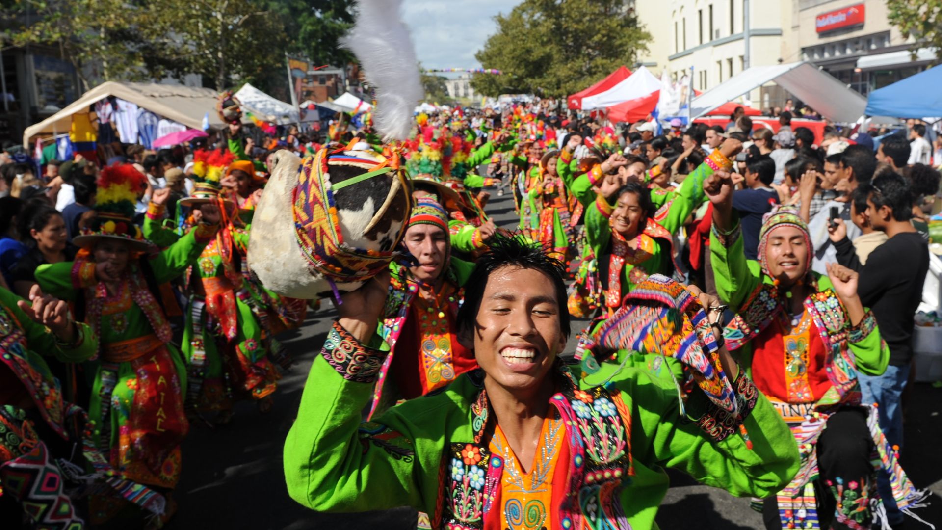 A Dancers with Tinkus Tiataco, from Bolivia, pass through the crowd during a parade at the 38th annual Fiesta DC, a Latino festival in DC's Mt Pleasant area.