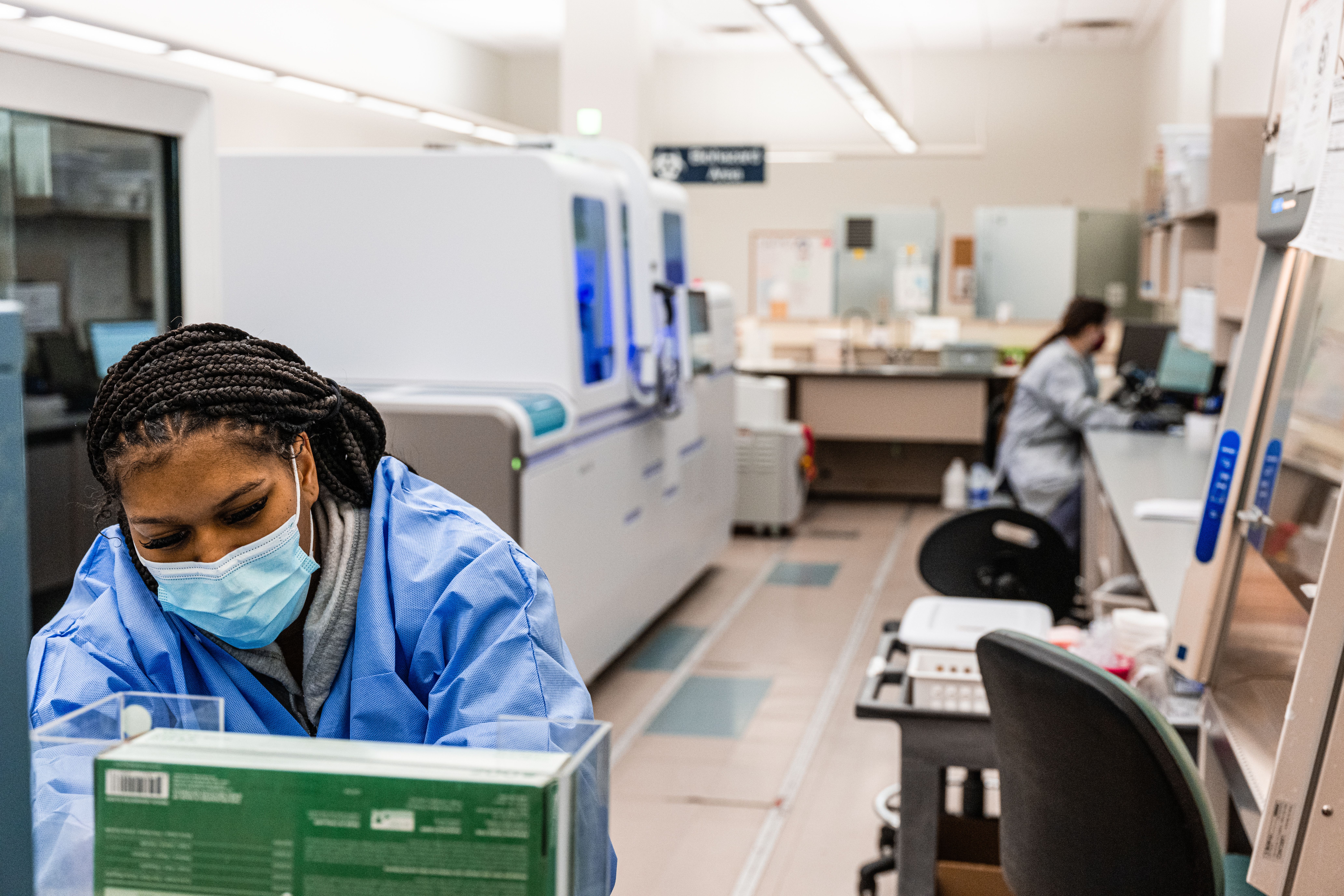 Deira Ward, a medical technologist, reaches for an item near a PCR analysis machine in the PCR testing lab at Quest Diagnostics on February 9, 2022 in Indianapolis, Indiana.