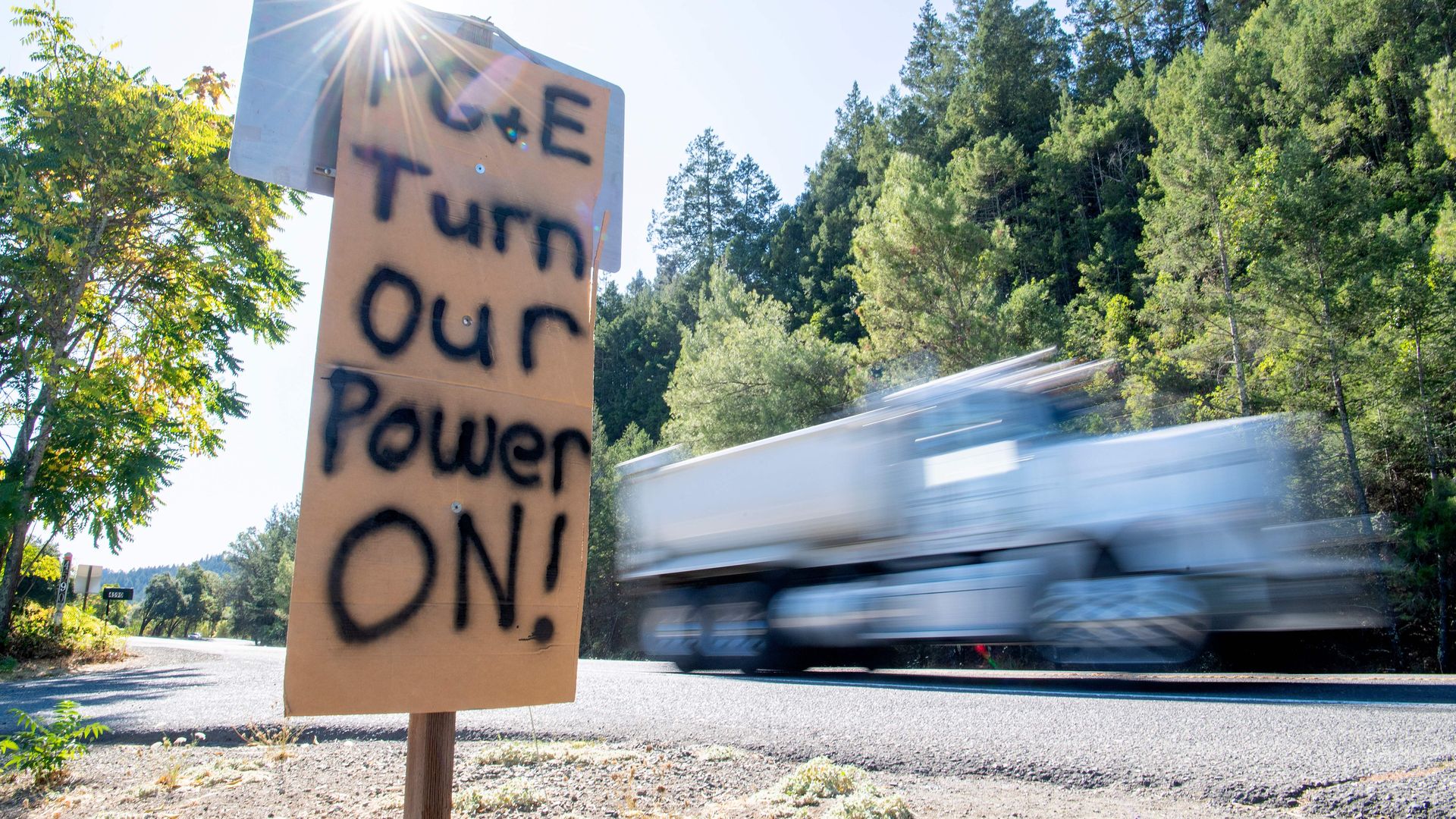 A sign calling for PG&E to turn the power back on is seen on the side of the road during a statewide blackout in Calistoga, California, on October, 10, 2019 