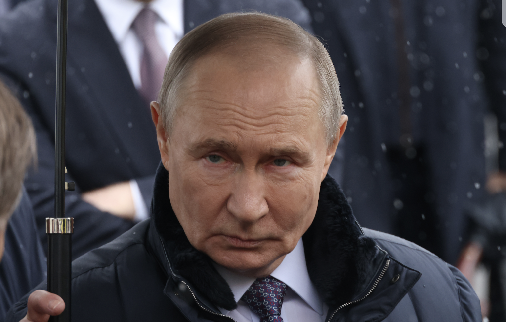 Vladimir Putin holds an umbrella while visiting the Federal Center For Disaster Medicine, on April 28, 2026 in Moscow.