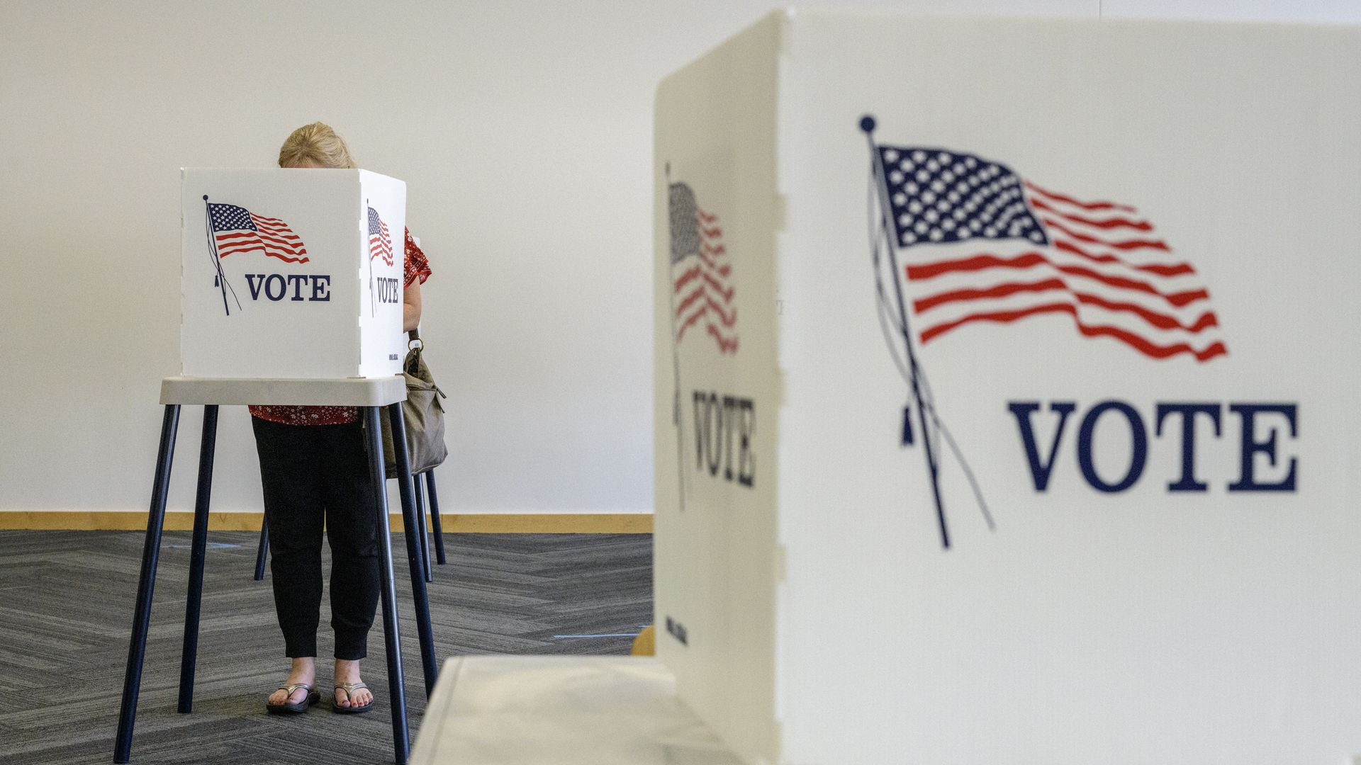 A voter fills out a ballot at the Ames Public Library on primary Election Day on June 7, 2022 in Ames, Iowa.
