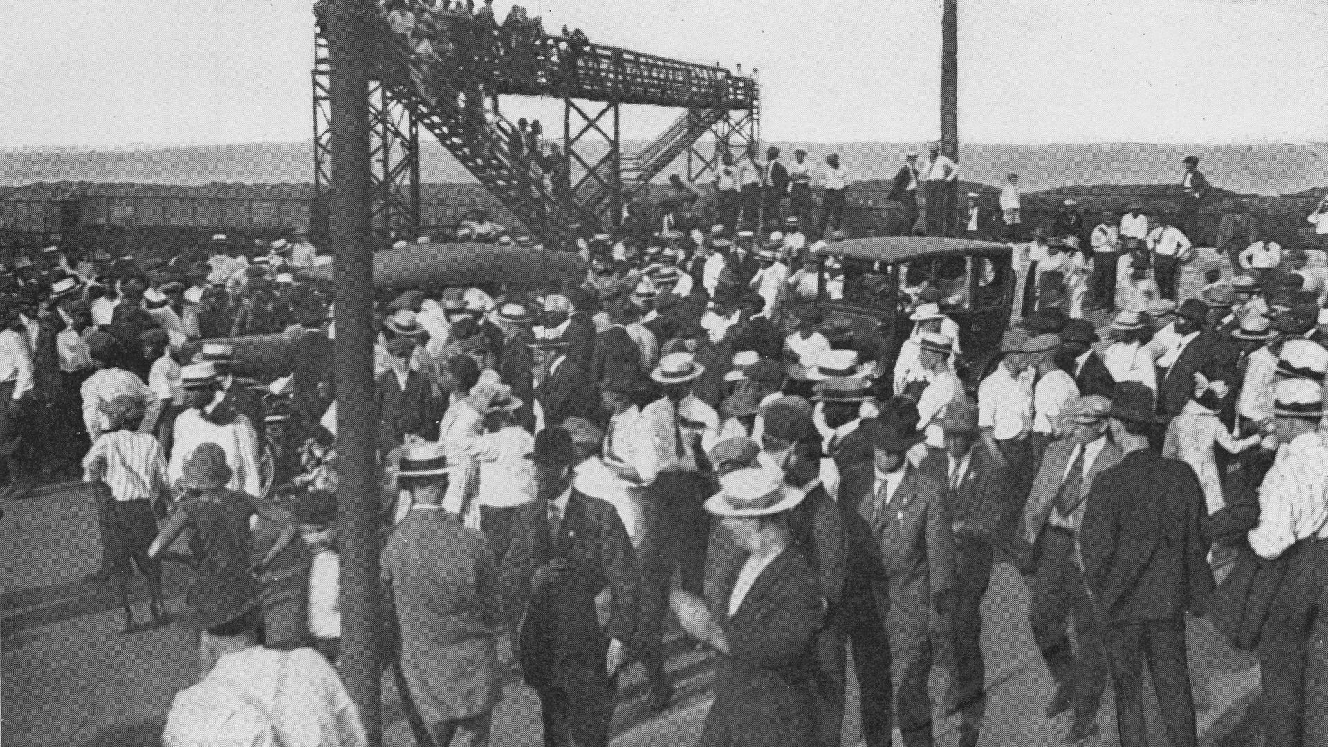 Photo of people leaving a beach. 