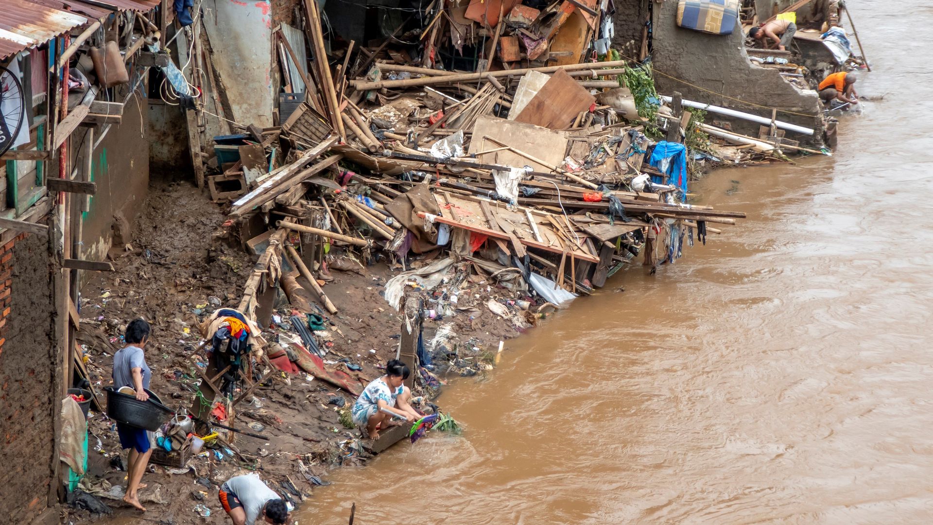 Indonesians clean their homes and cutlery along the river in Jakarta, Indonesia