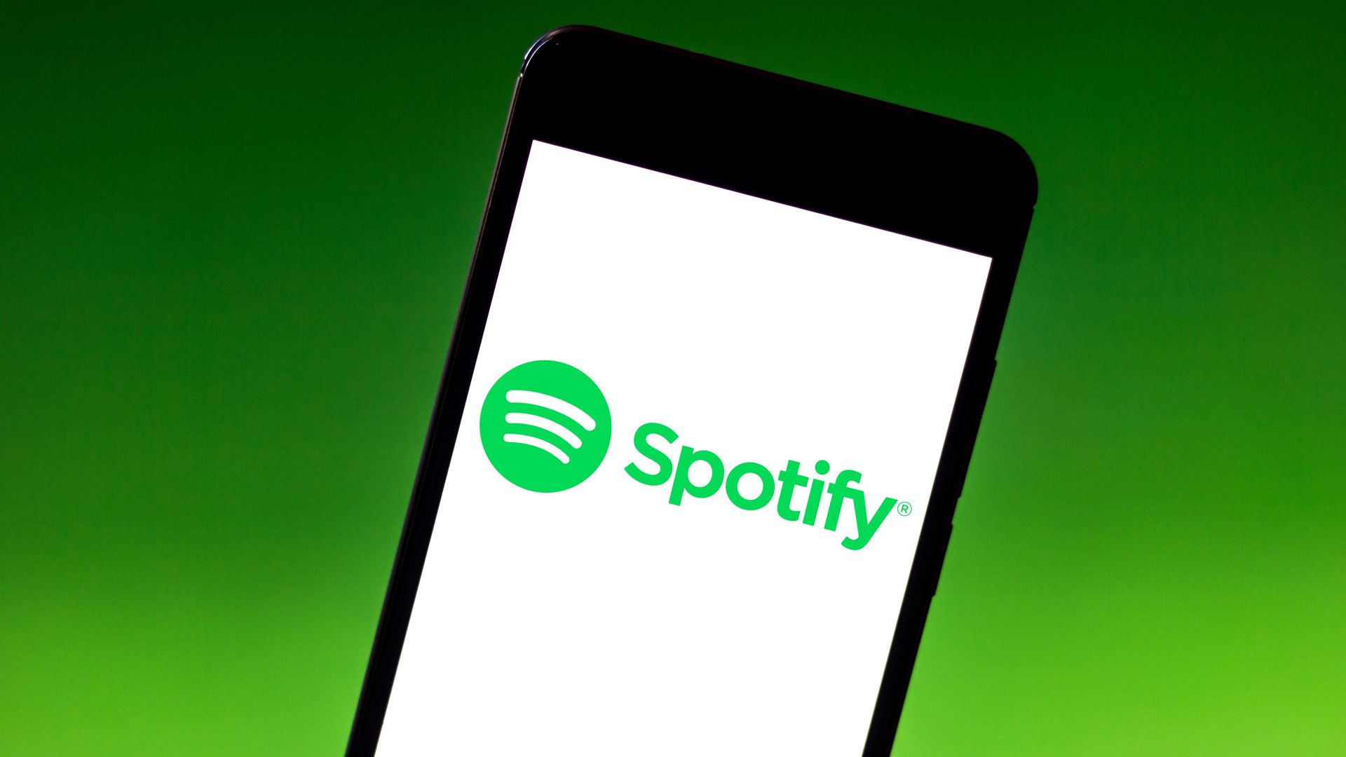 : In this photo illustration the Spotify logo is seen displayed on a smartphone.