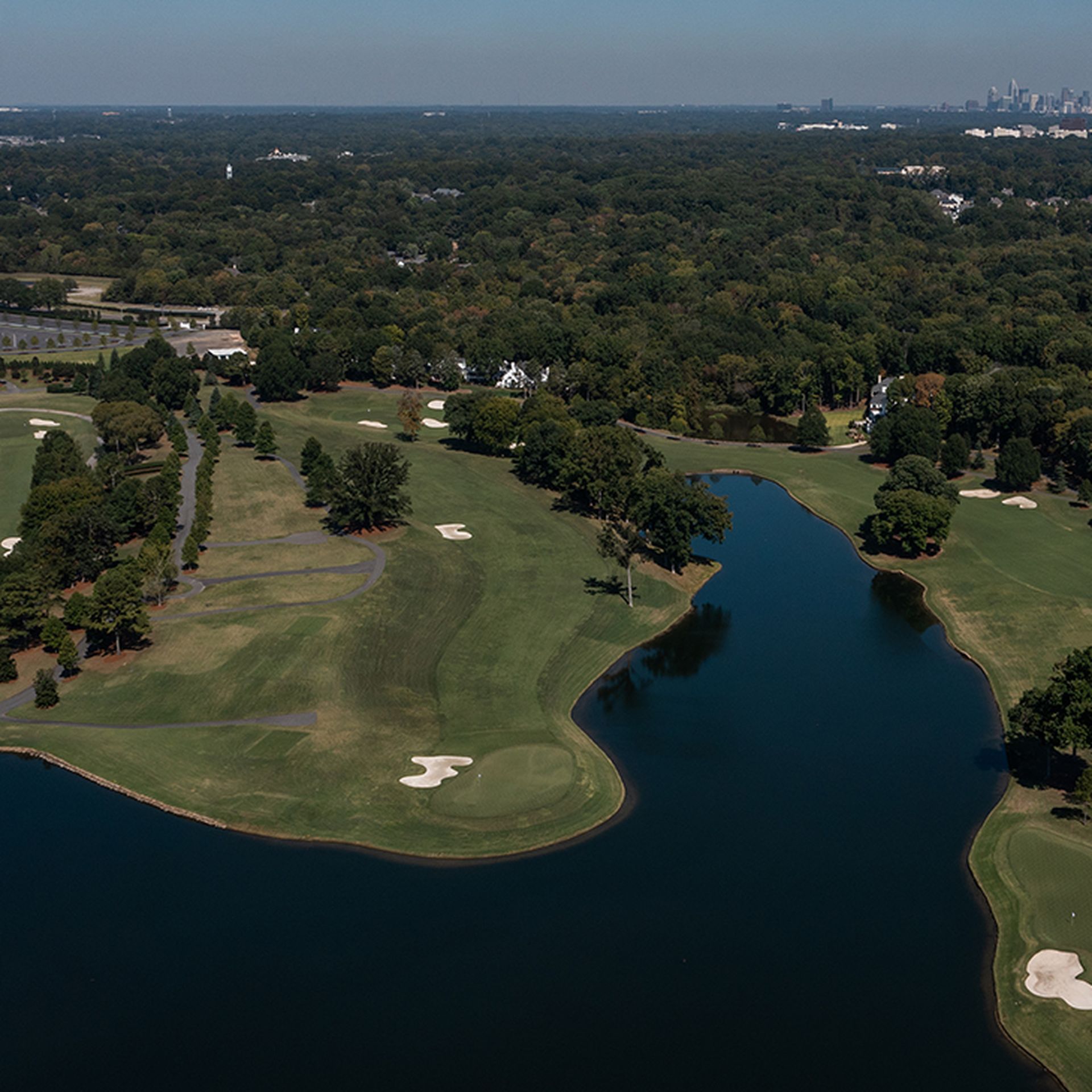 photo of Quail Hollow Golf Club with the Charlotte skyline in the distance
