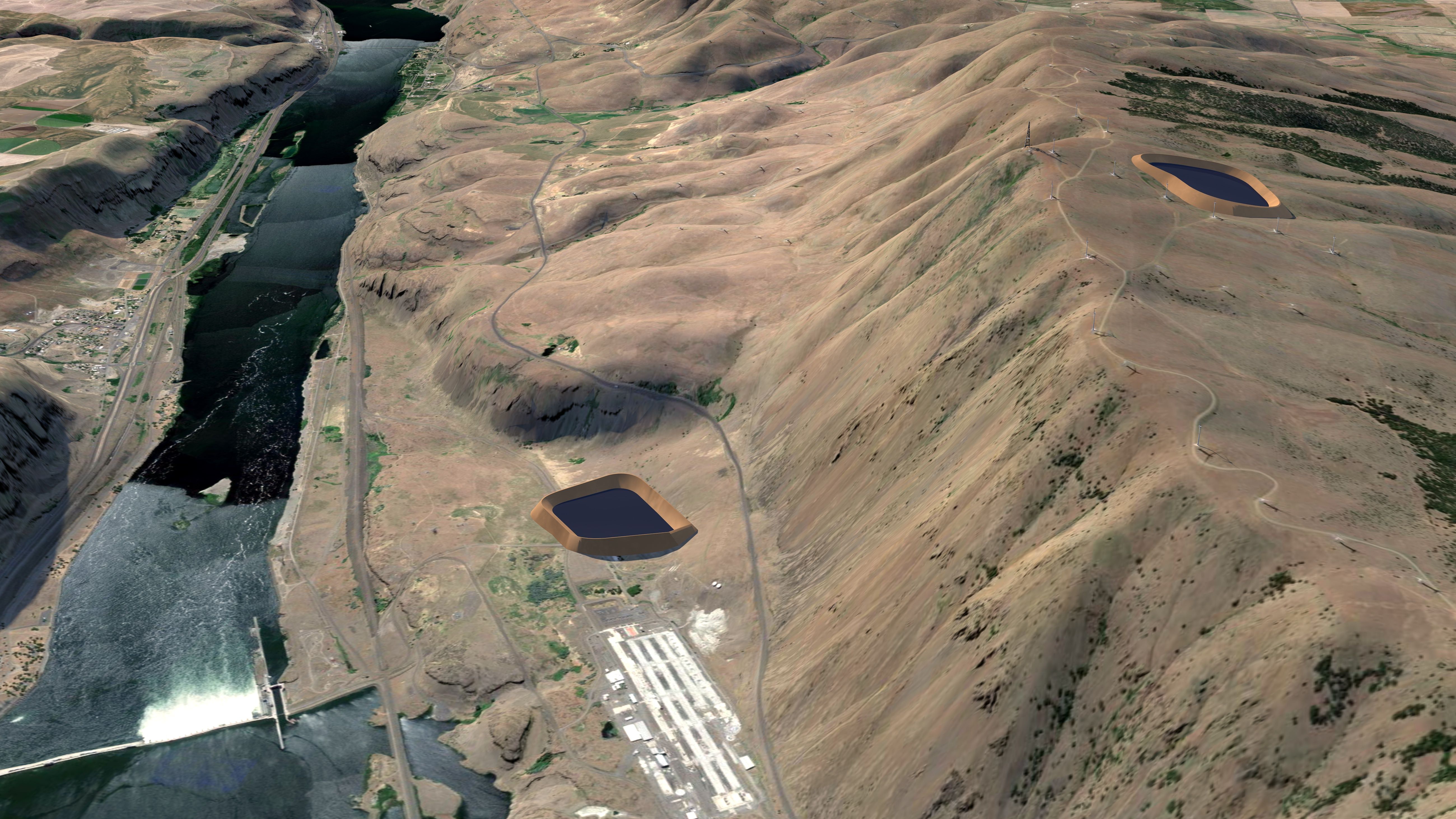 Aerial view of a river flowing through a dry, brown hilly landscape with a dam, roads, wind turbines on the ridge, and two dark, artificial ponds on the hills.