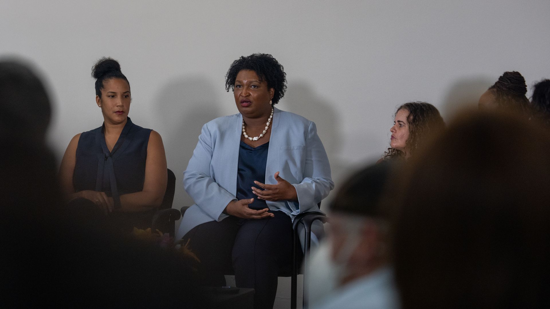 Stacey Abrams sitting next to other women