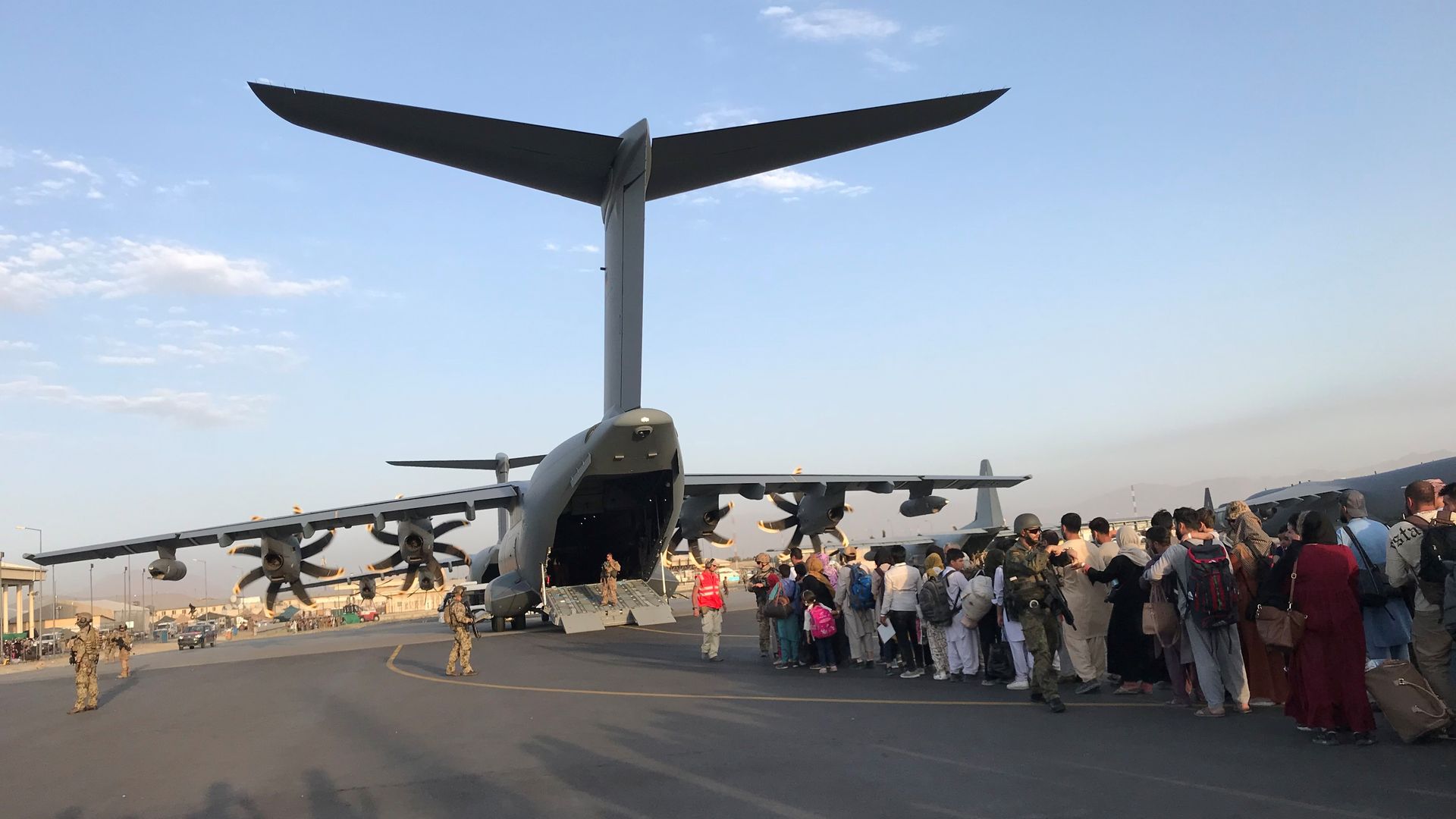 Afghans are seen lining up to board a German transport after the fall of Kabul.