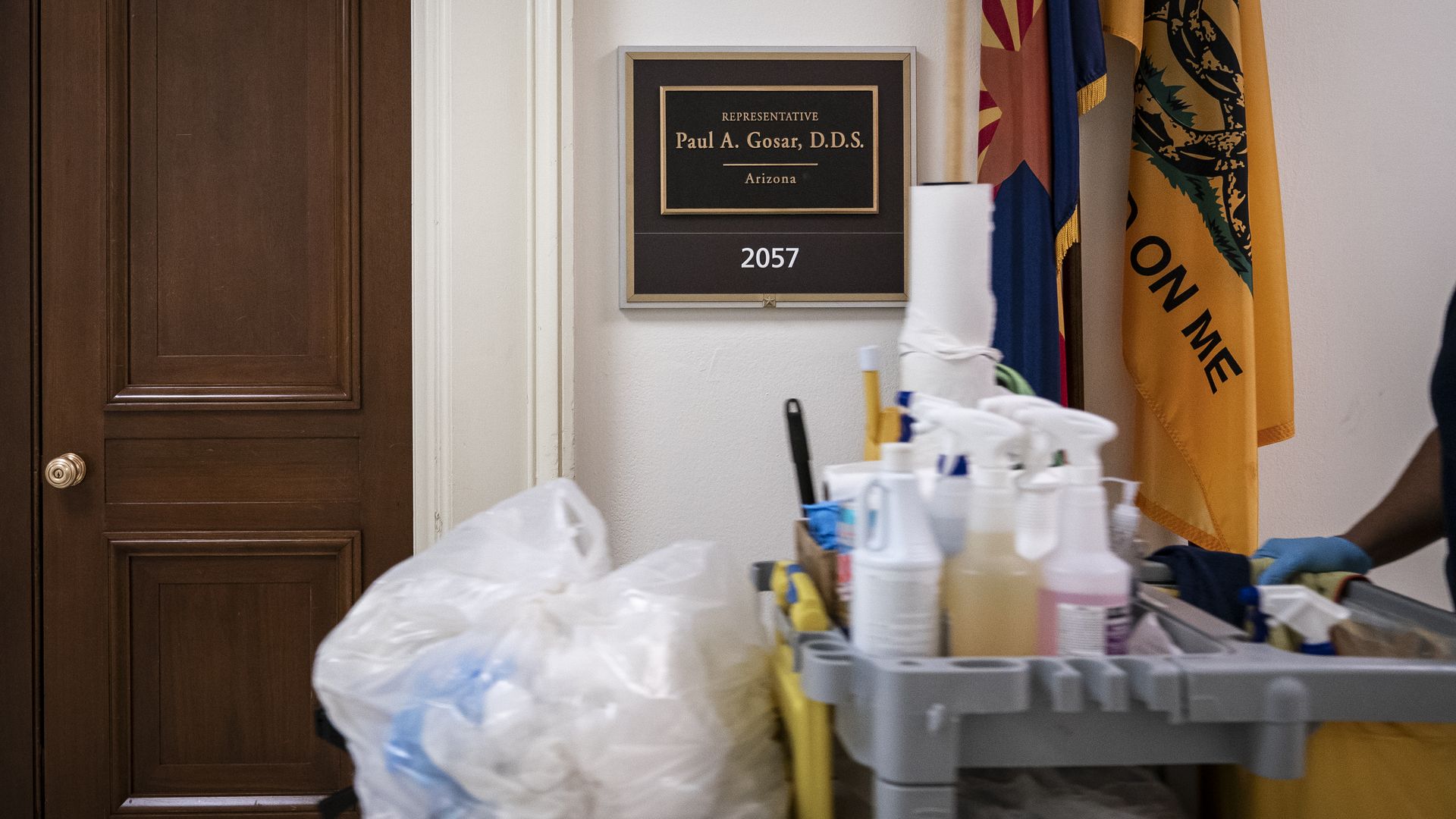 An Architect of the Capitol custodial staff member walks past U.S. Rep. Paul Gosar's (R-AZ) closed office 