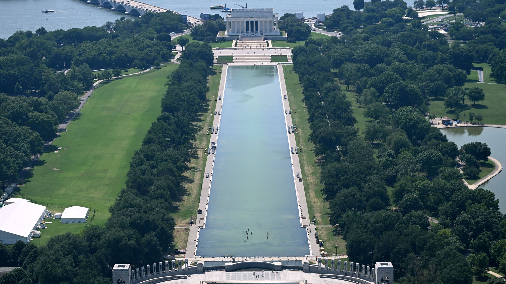 People work in the Lincoln Memorial reflecting pool as seen from the Washington Monument in Washington, DC, on June 30, 2026