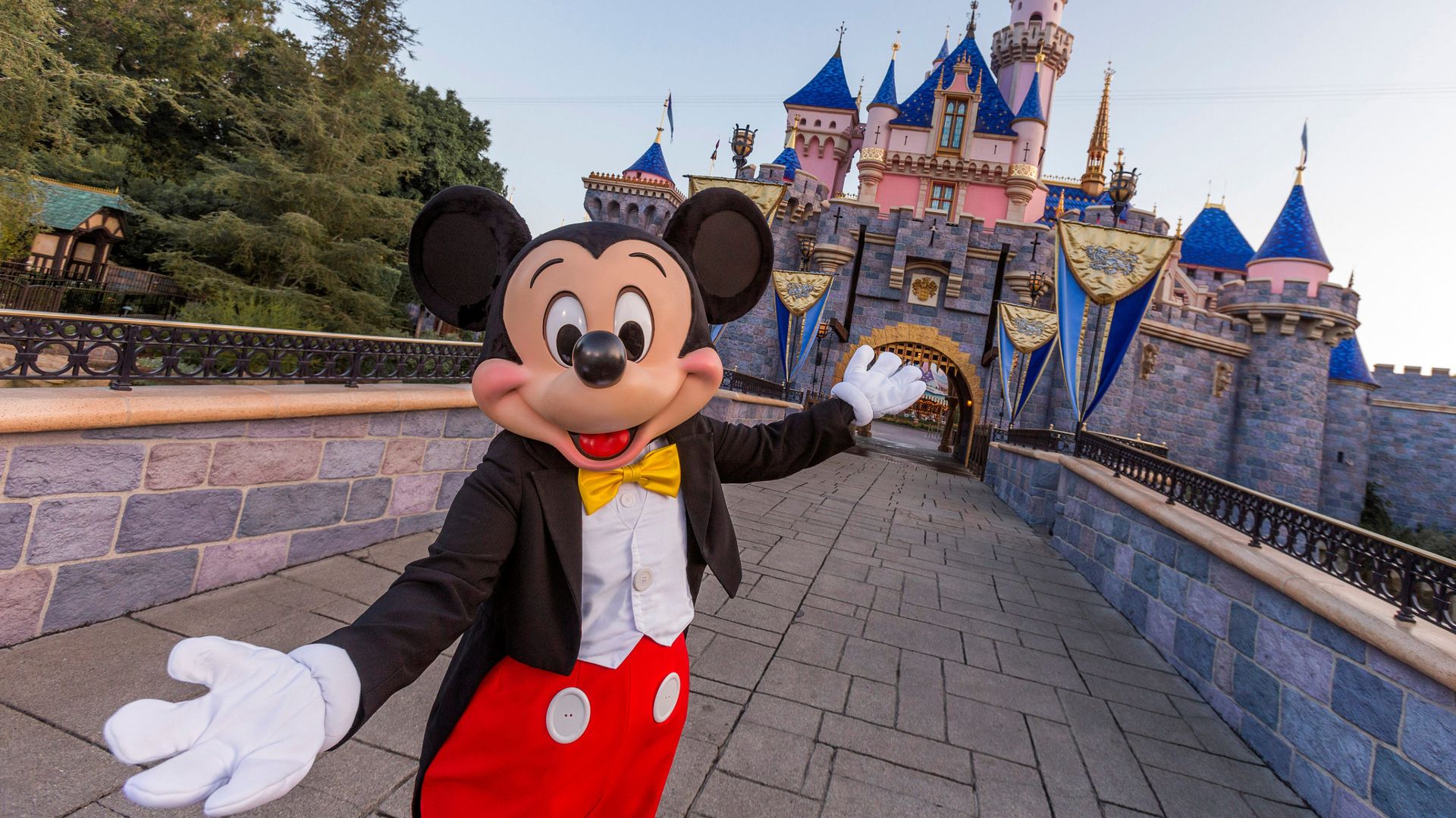 Mickey Mouse poses in front of Sleeping Beauty Castle at Disneyland Park on August 27, 2019 in Anaheim, California. 