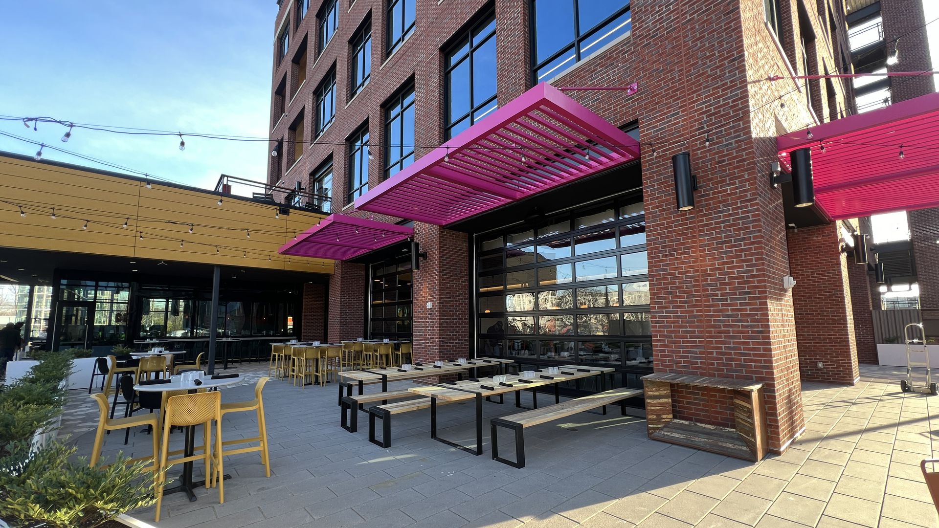 Outside of brick building with tables and chair outside