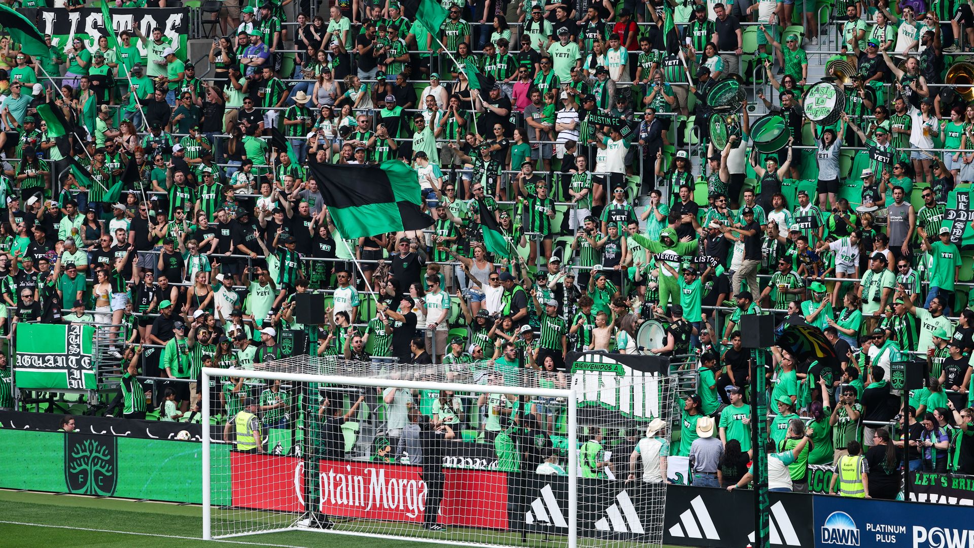A photo of Austin FC fans in the stands behind the goal.