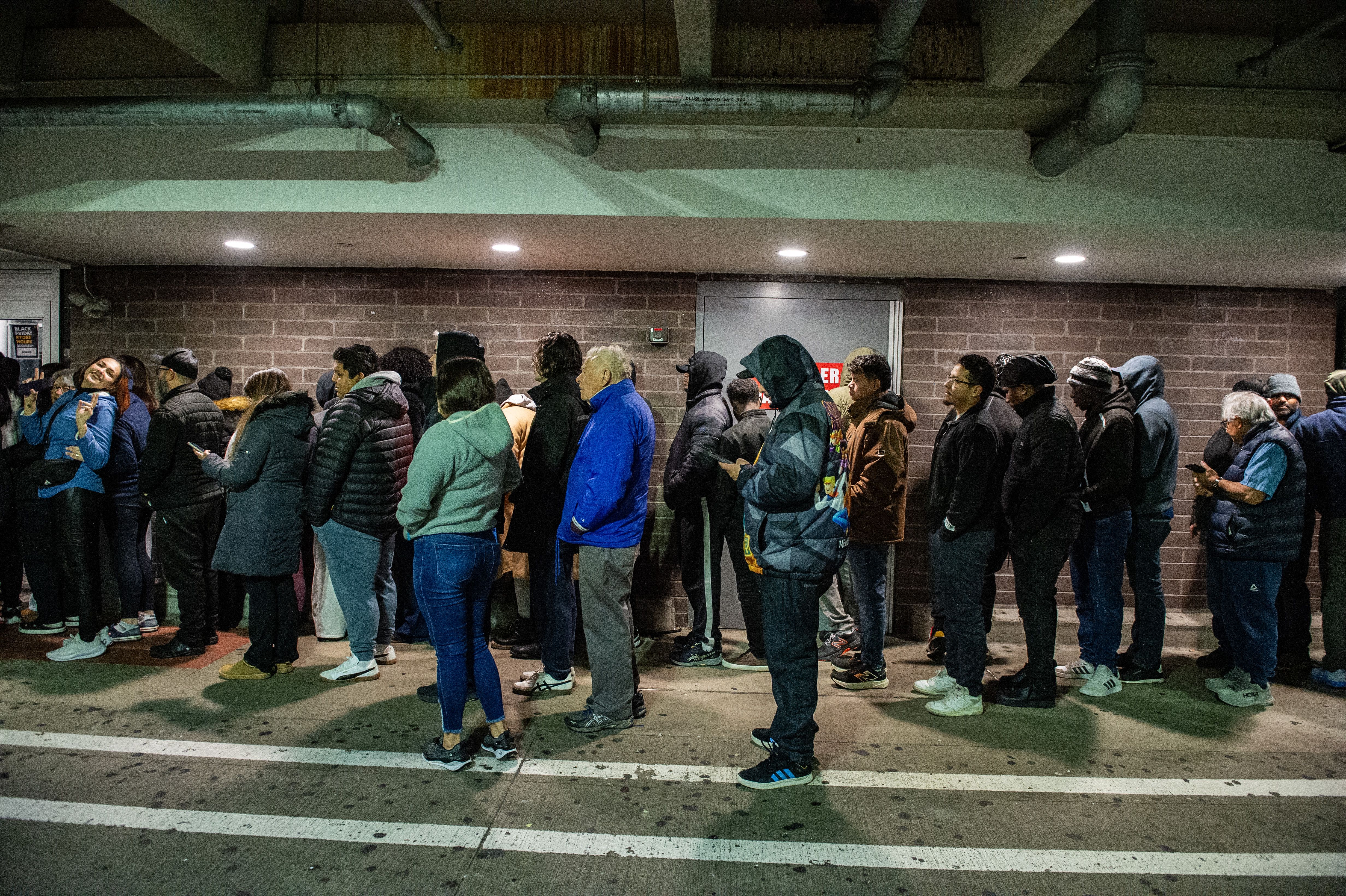 People wait in line for Walmart to open on Black Friday in Saugus, Massachusetts on November 28, 2025. The store opened at 6am to allow shoppers to get special deals on goods for the holiday season. (Photo by JOSEPH PREZIOSO / AFP via Getty Images)
