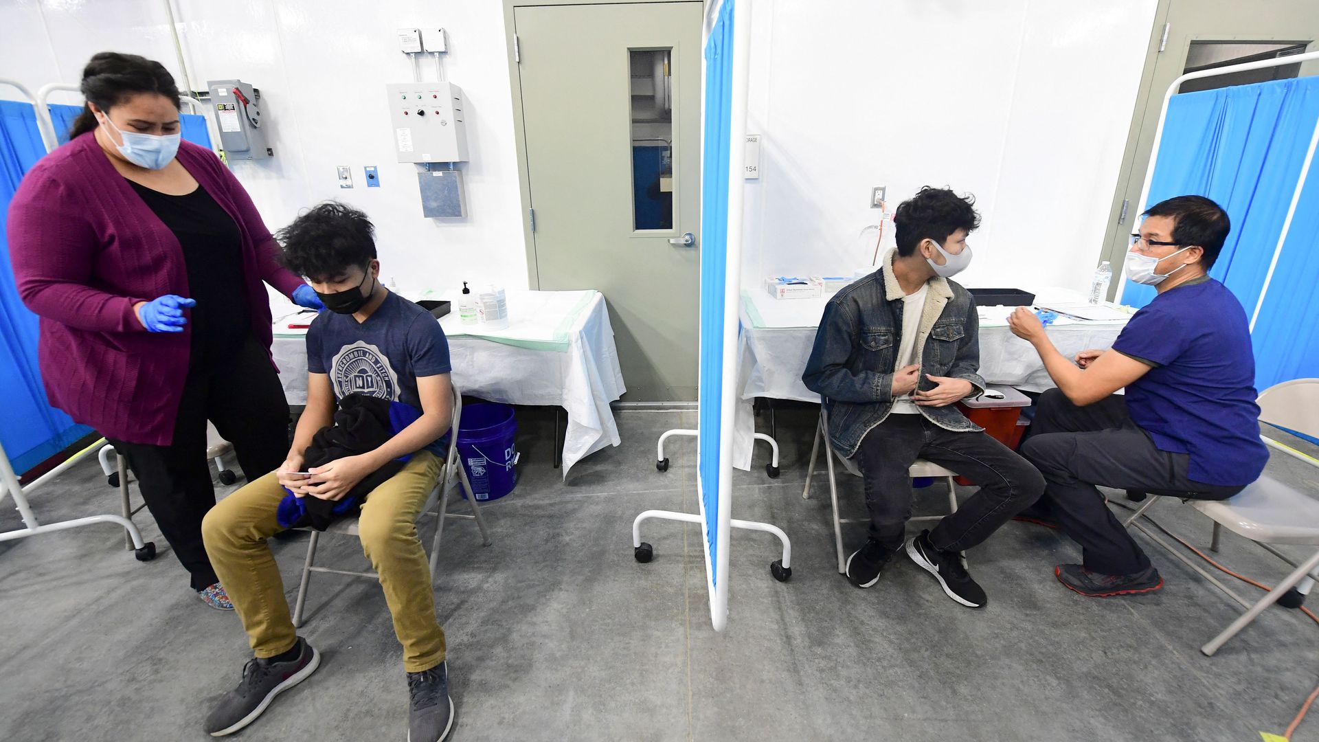 Two brothers receive the Covid-19 vaccine at the Blood Bank of Alaska in Anchorage