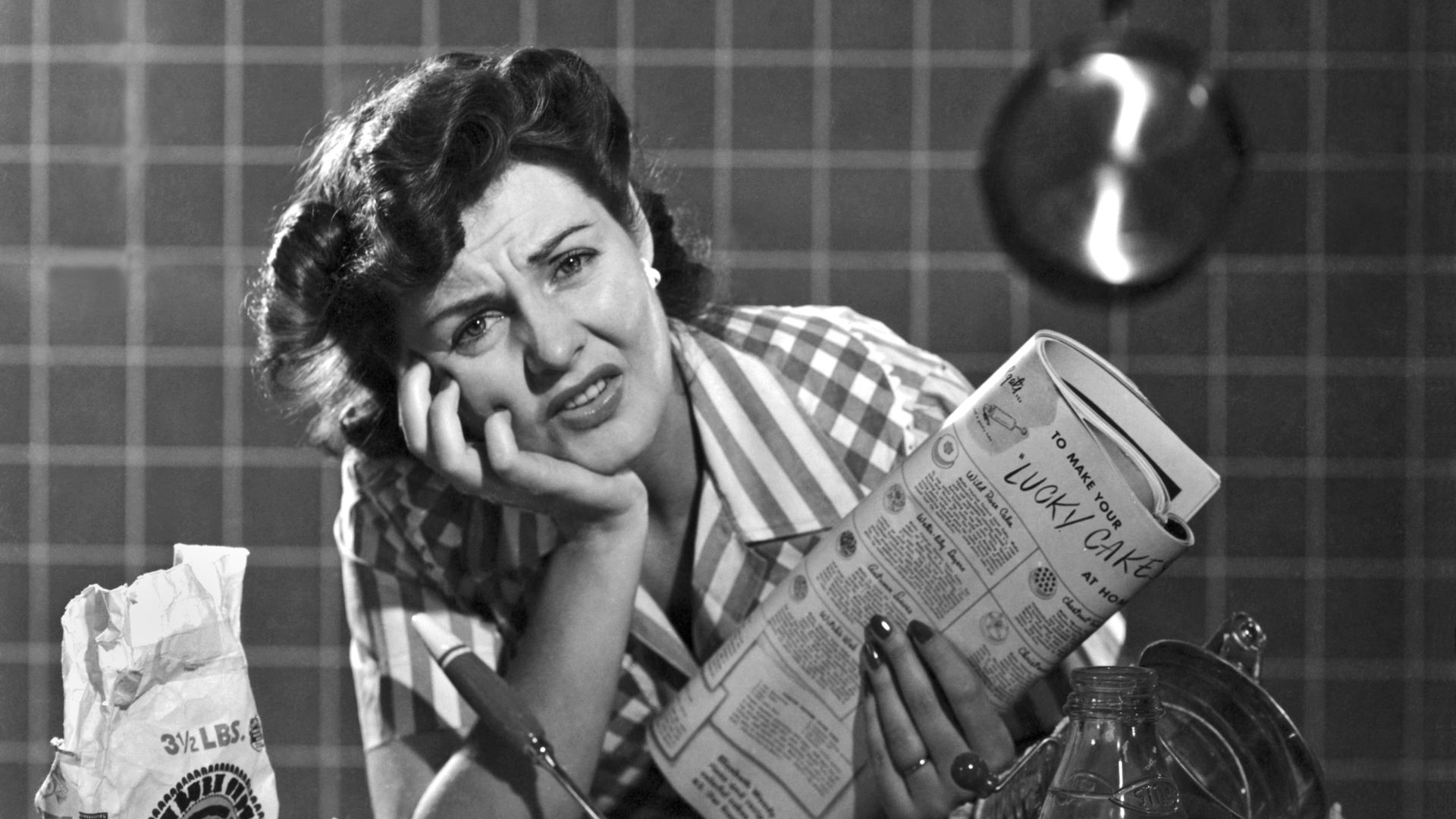 A woman looks frustrated while baking