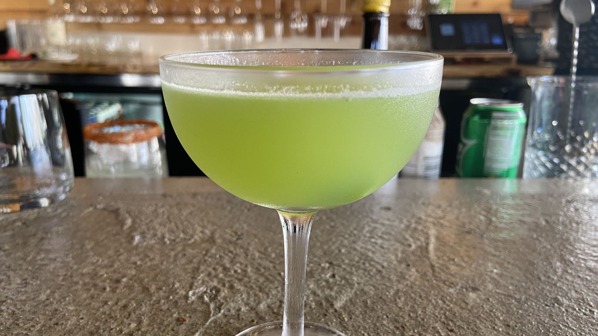 A photo of a cucumber gimlet on a bar 