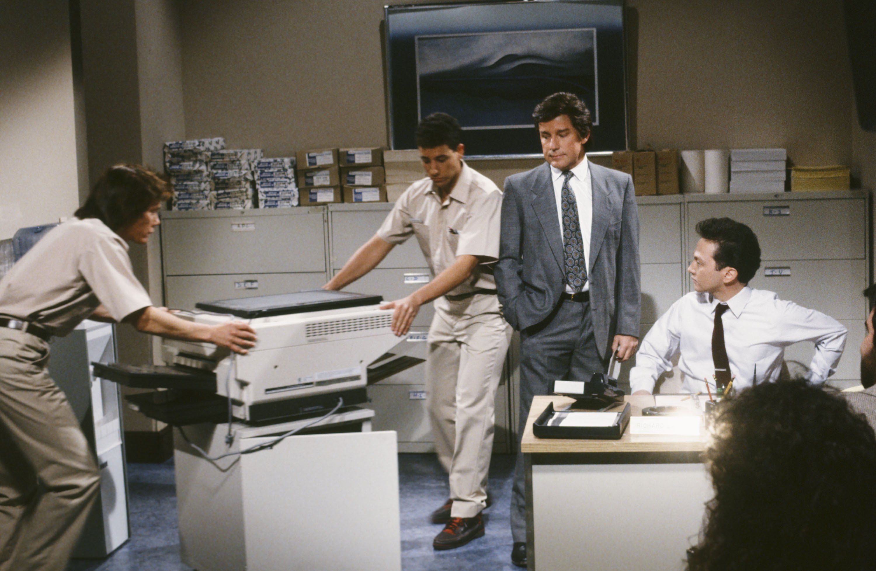 People moving a copy machine. 