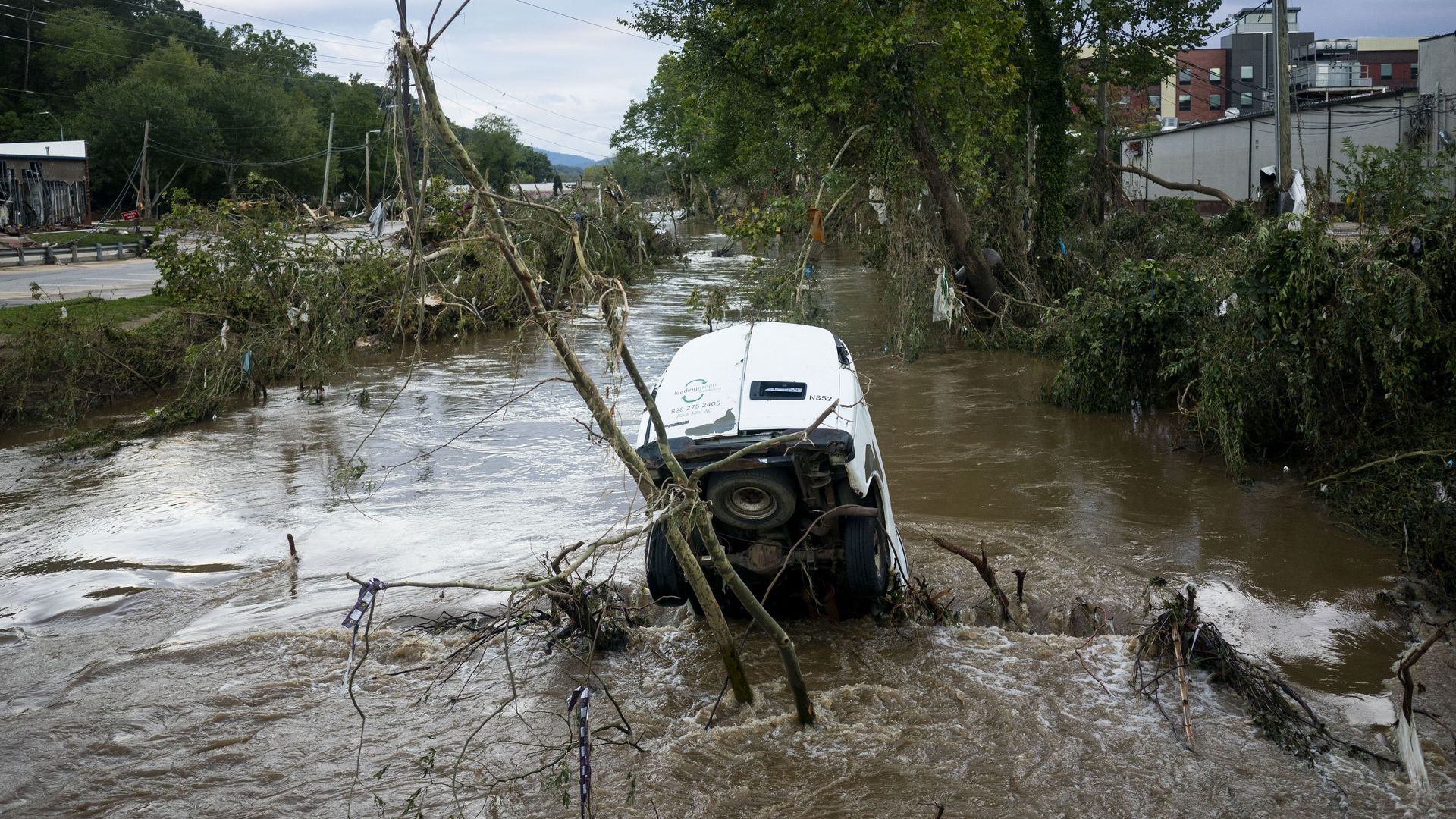 A van submerged in flooded streets. 