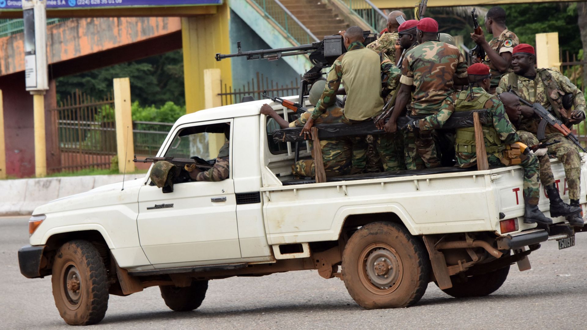 Members of the Armed Forces of Guinea drive through the central neighborhood of Kaloum on Sept. 5.