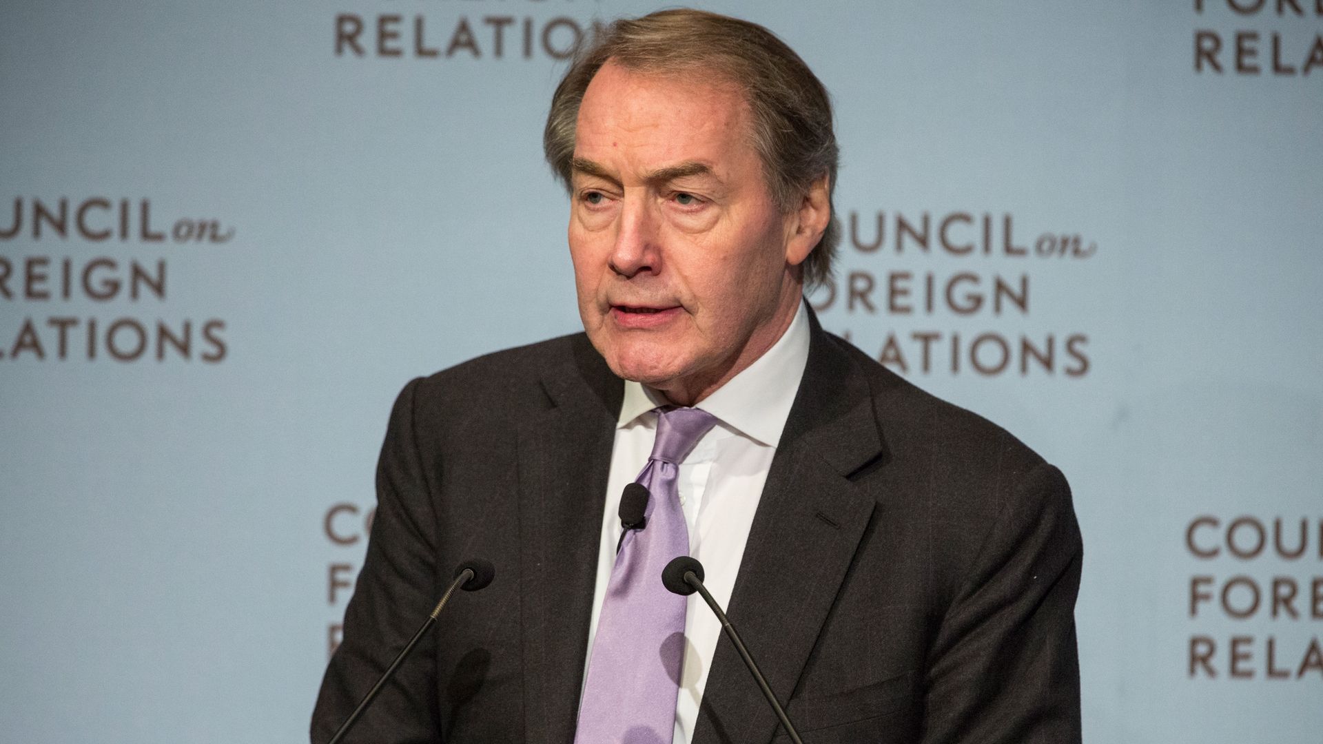 Journalist Charlie Rose standing at a podium from 2015
