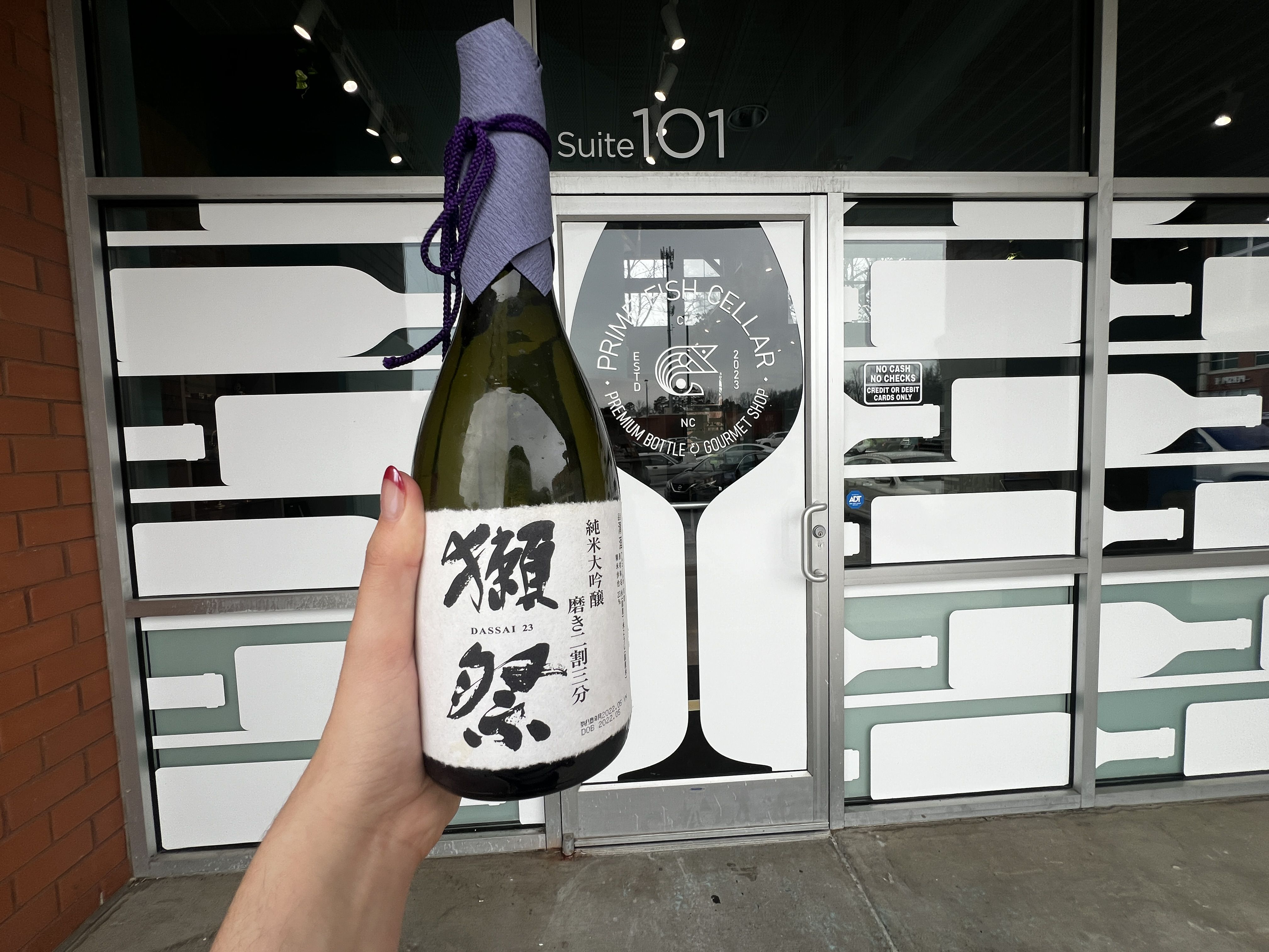 hand holding sake bottle