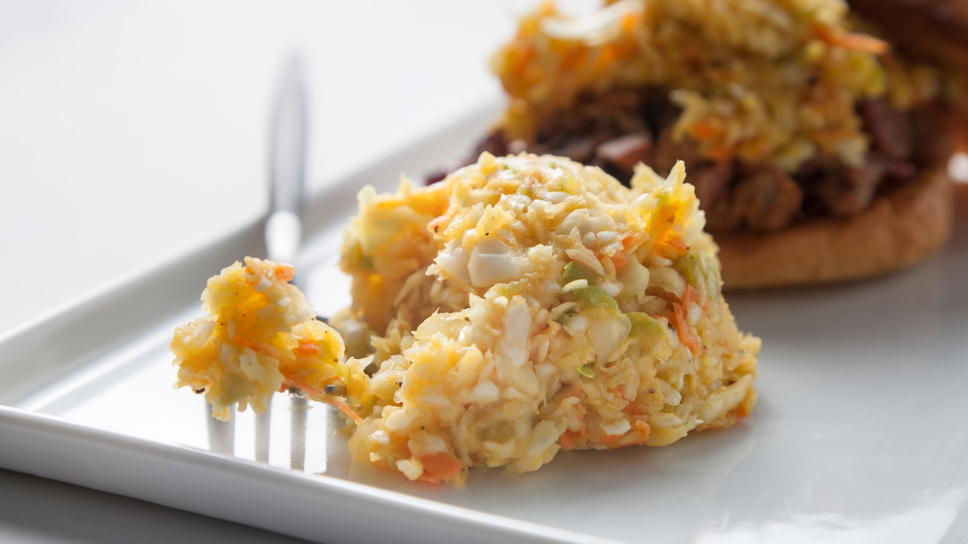 A pile of yellow coleslaw.