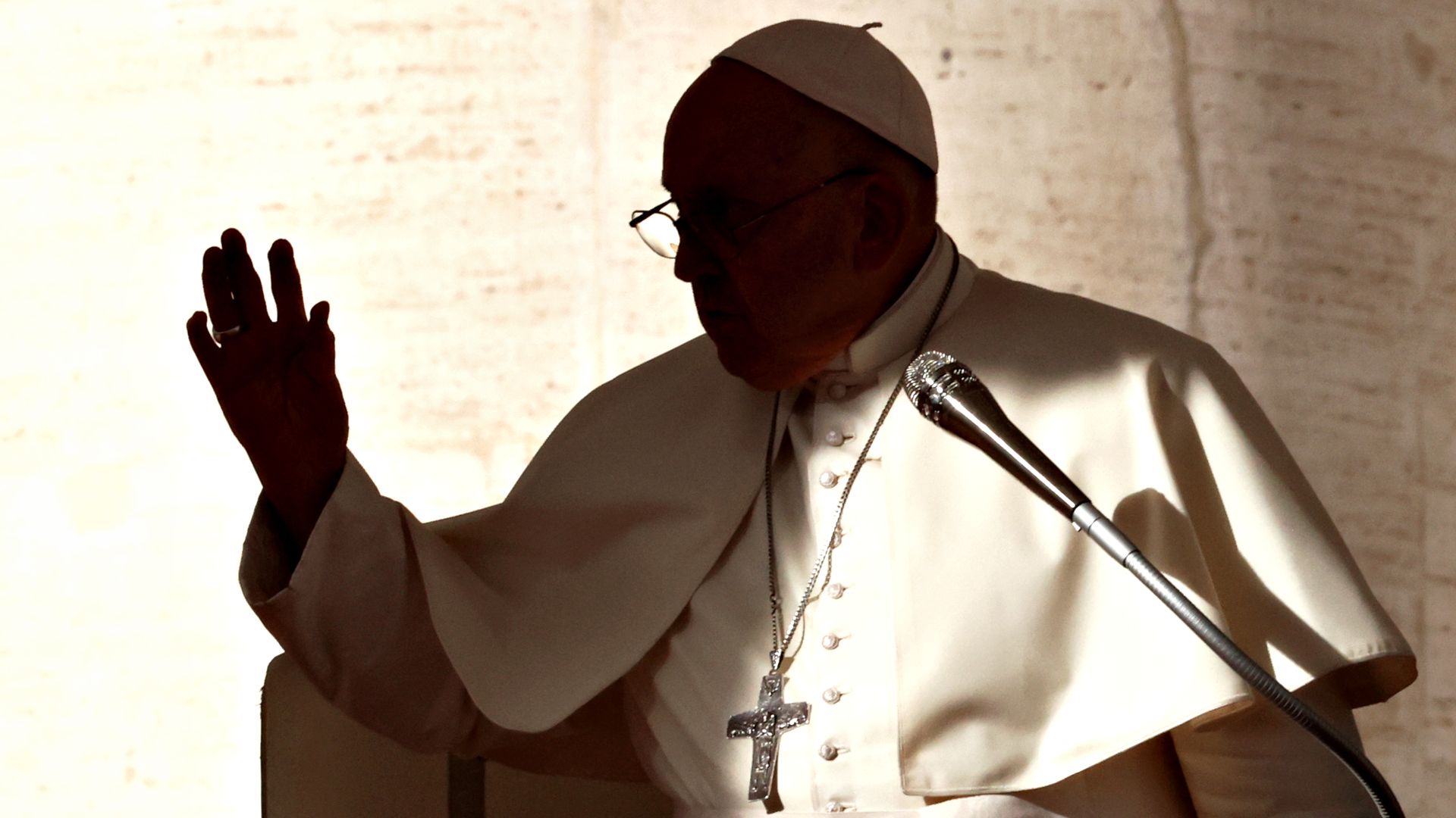 A sillhouetted image of Pope Francis. 