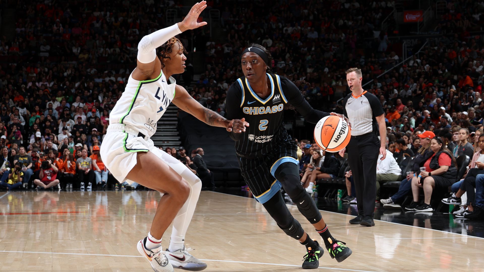 Kahleah Copper dribbles a basketball, trying to evade a defender of the Minnesota Lynx.