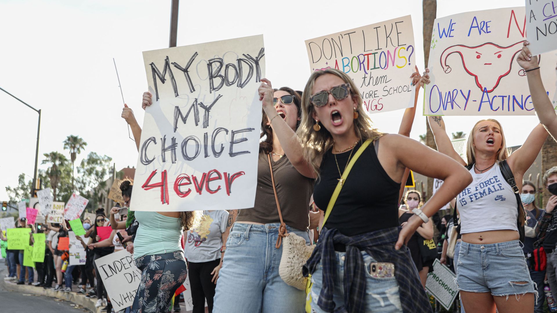 Picture of abortion rights protesters holding signs that say "my body my choice 4ever"