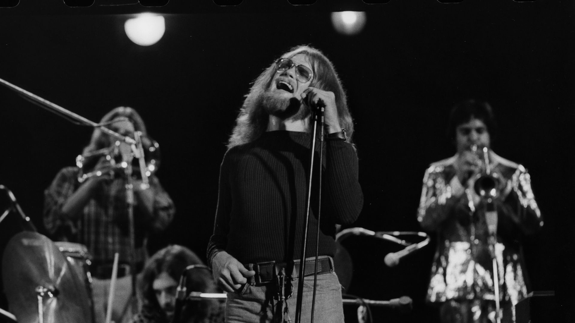 The members of Blood, Sweat & Tears perform on stage. 