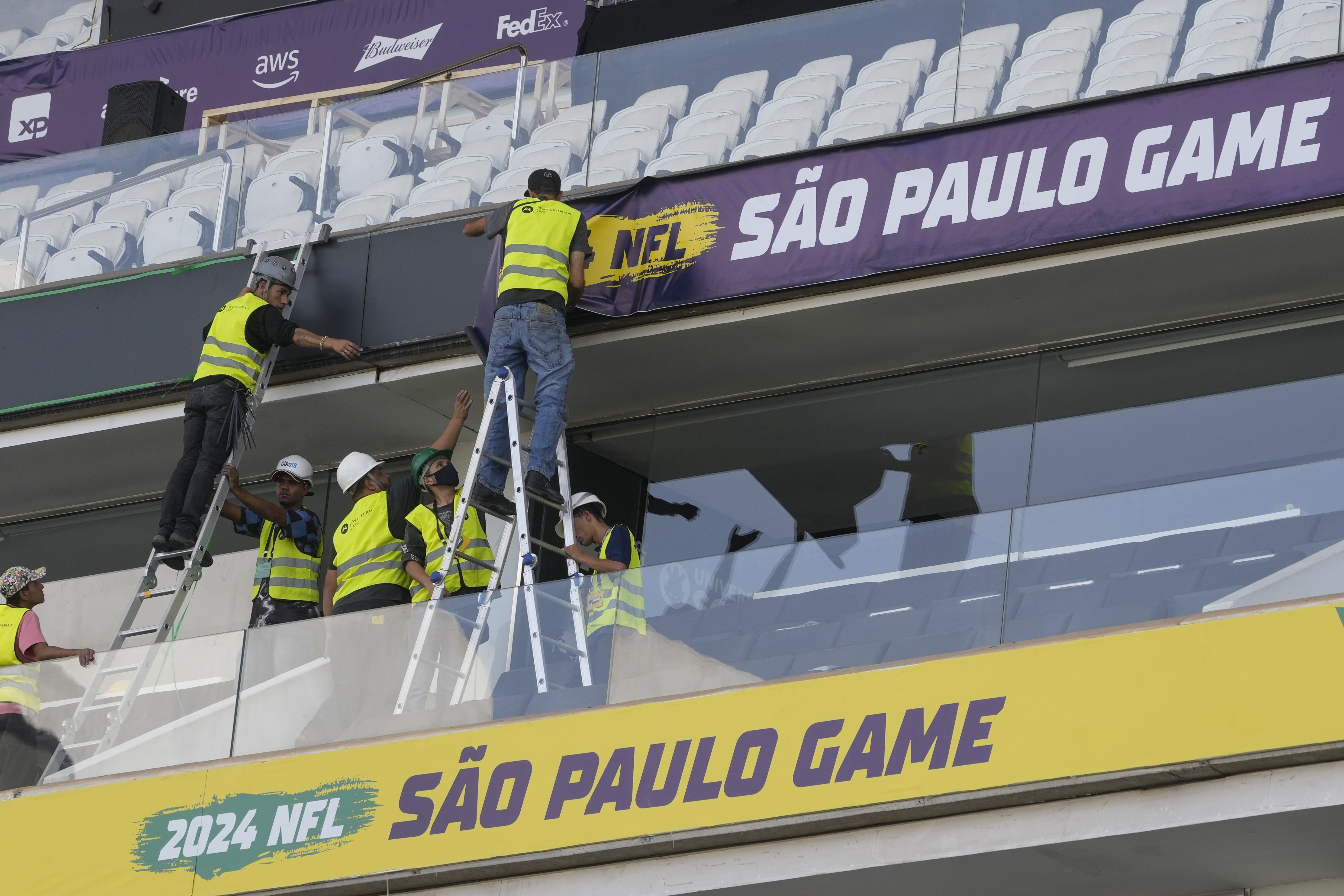 Workers prepare Corinthians Arena in São Paulo, Brazil, for the Packers-Eagles game on Friday.