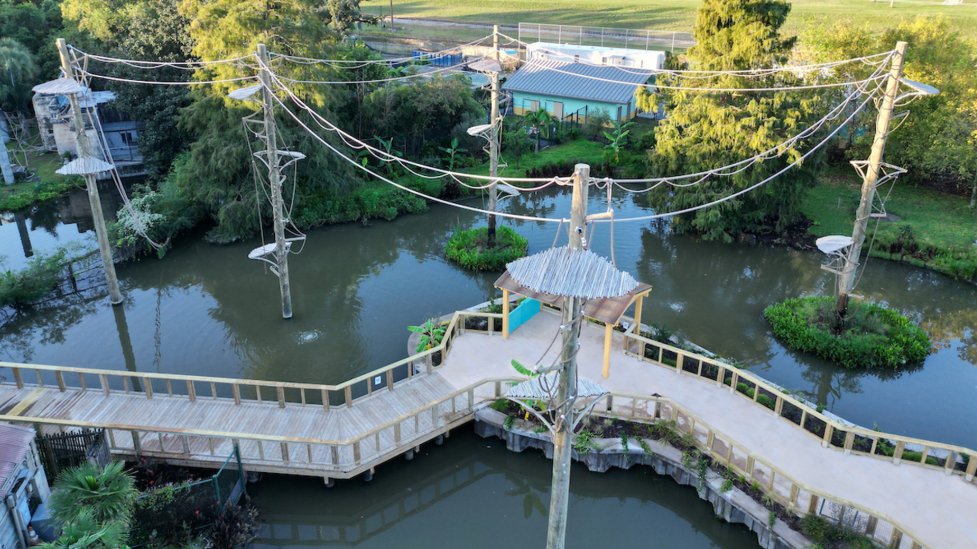 Photo shows poles with ropes over a lagoon.