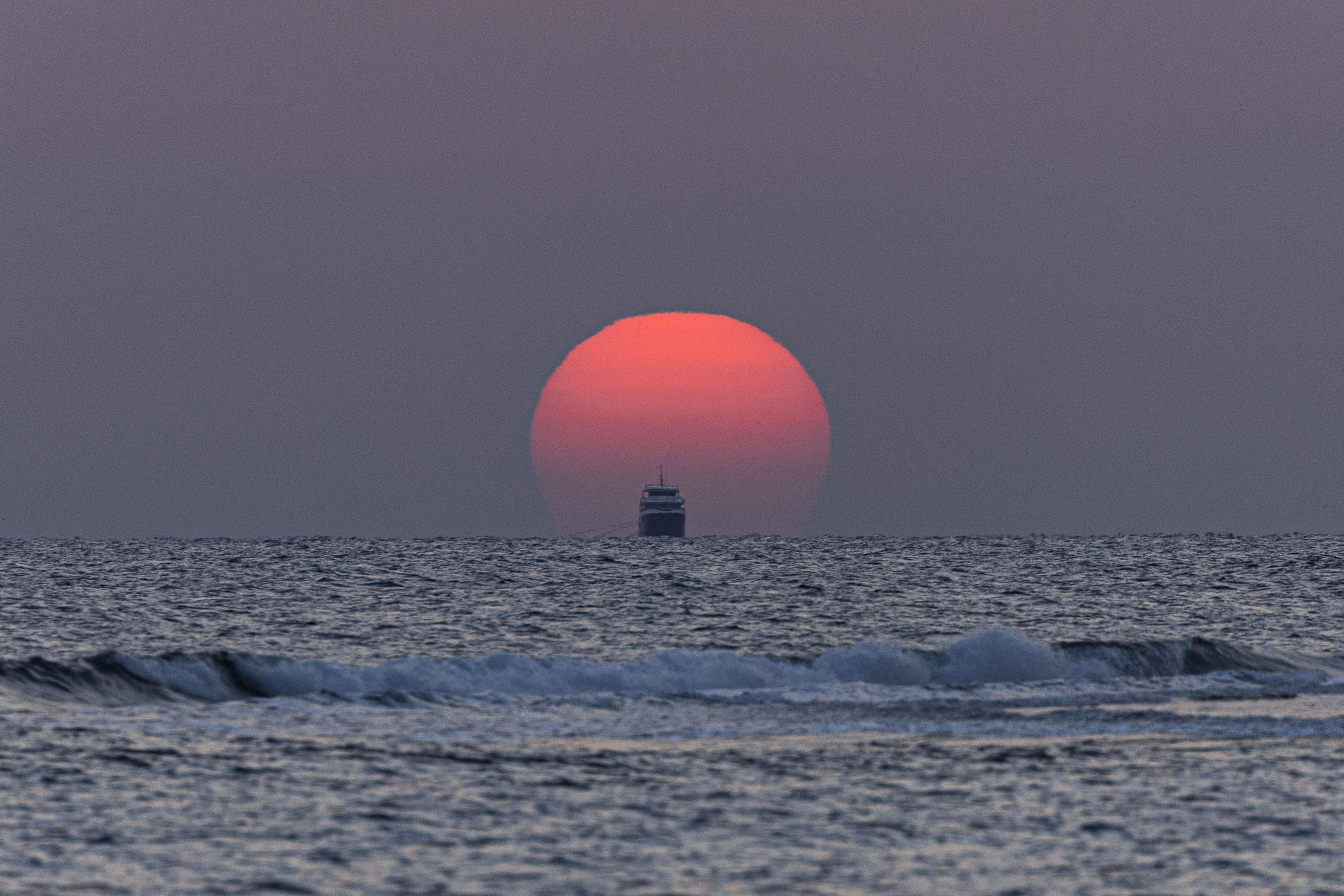 The sun rises over the Red Sea at Abu Dabbab Bay, illuminating the coastline near Marsa Alam, Egypt.