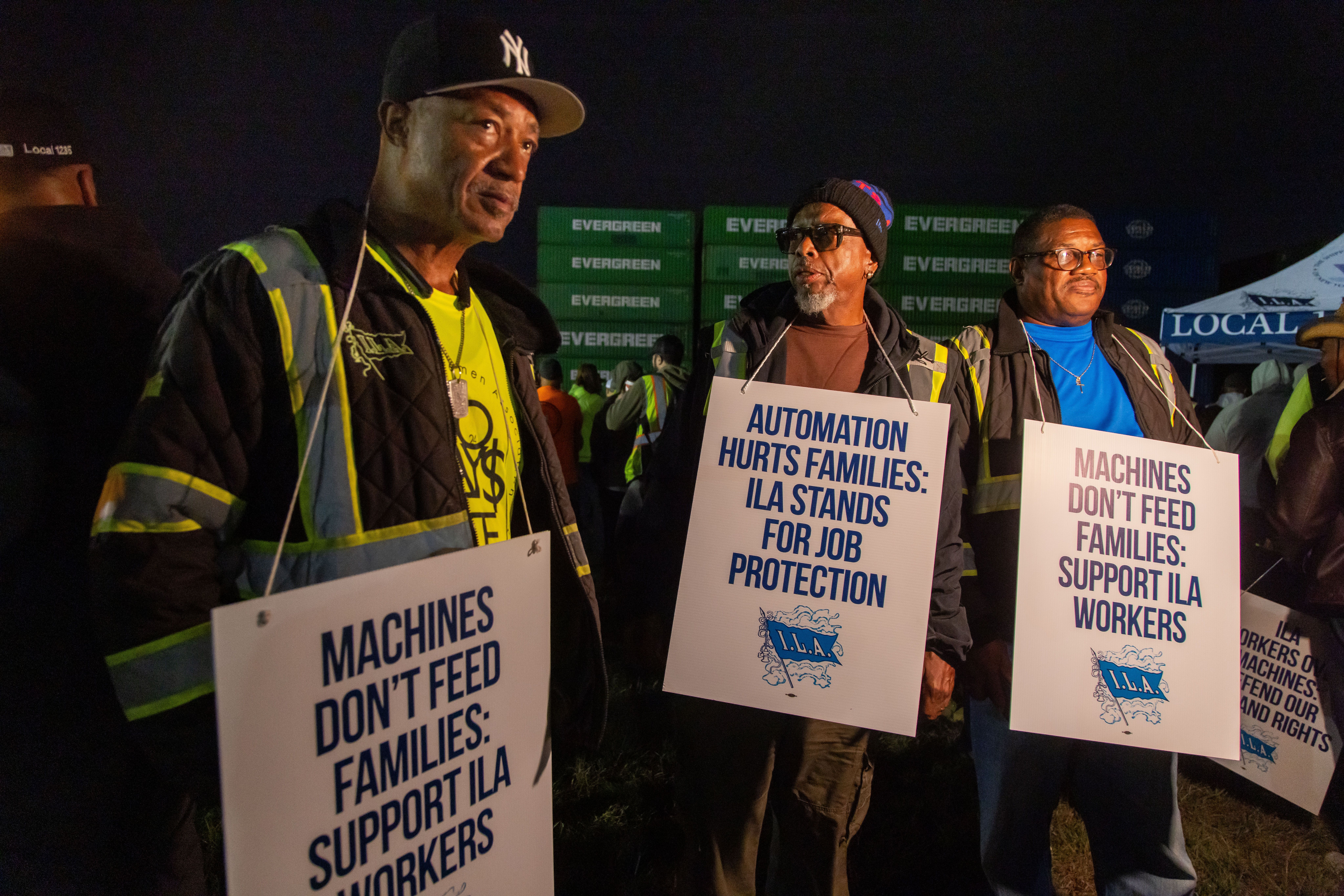 Workers picket outside the APM container terminal at the Port of Newark. 