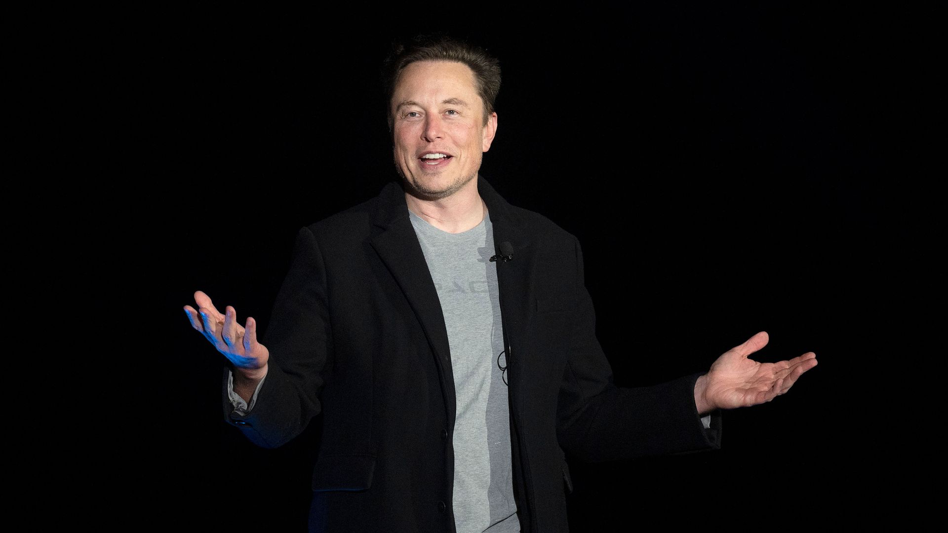 Elon Musk gestures as he speaks during a press conference
